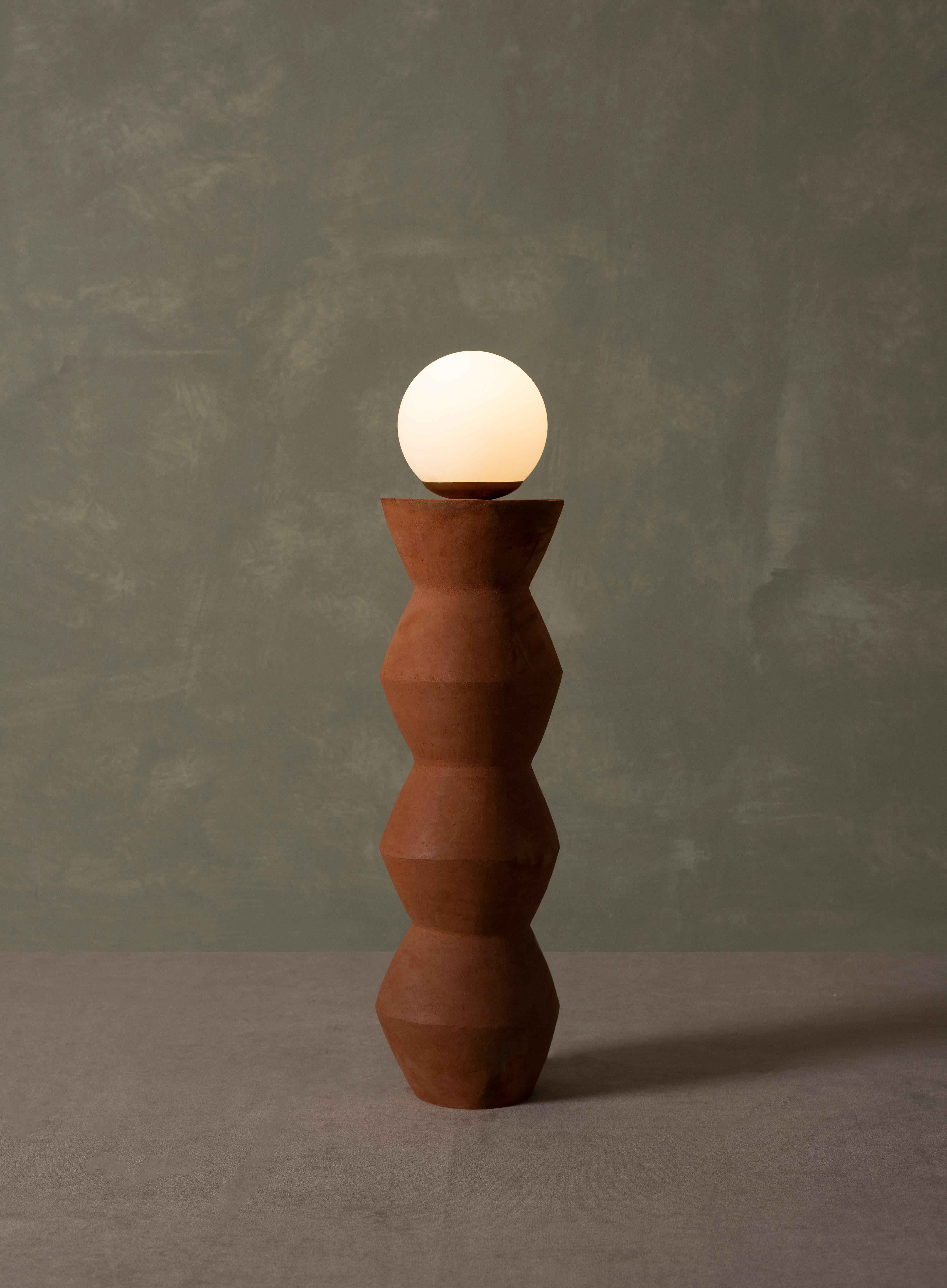 Somos Standing Lamp by Estudio Calido
Dimensions: D 19 x W 19 x H 80 cm.
Materials: Terracota Clay, Glass. 
Weight: 7 kg. 

In regards to our Production Process: since it is a handmade process, dimensions may vary. With the Terracotta lamps it
