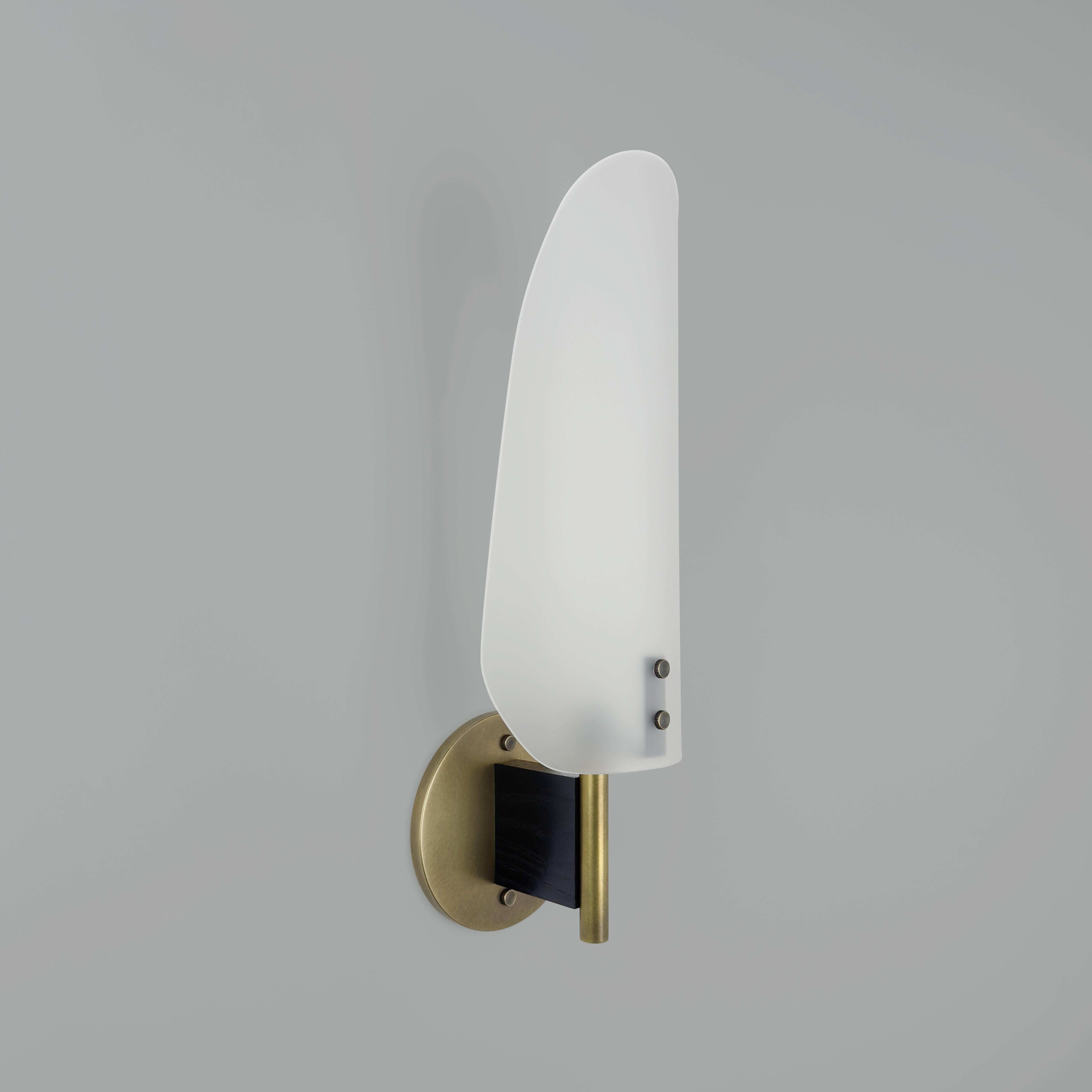 El aplique Sonata Tipo 1 es un aplique moderno hecho a mano, diseñado pensando en el diseñador de interiores exigente y el cliente residencial de alto nivel. Mostrado en Bronce envejecido, madera teñida de negro y una pantalla de cristal grabado a