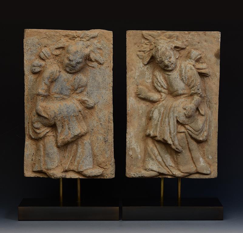 A pair of antique Chinese pottery brick tile with musician drummers.

Age: China, Song Dynasty, 10th - 12th Century
Size excluding stand: Height 30.2 - 30.8 C.M. / Width 18.3 - 19.2 C.M.
Height including stand: 38.2 - 38.4 C.M.
Condition: