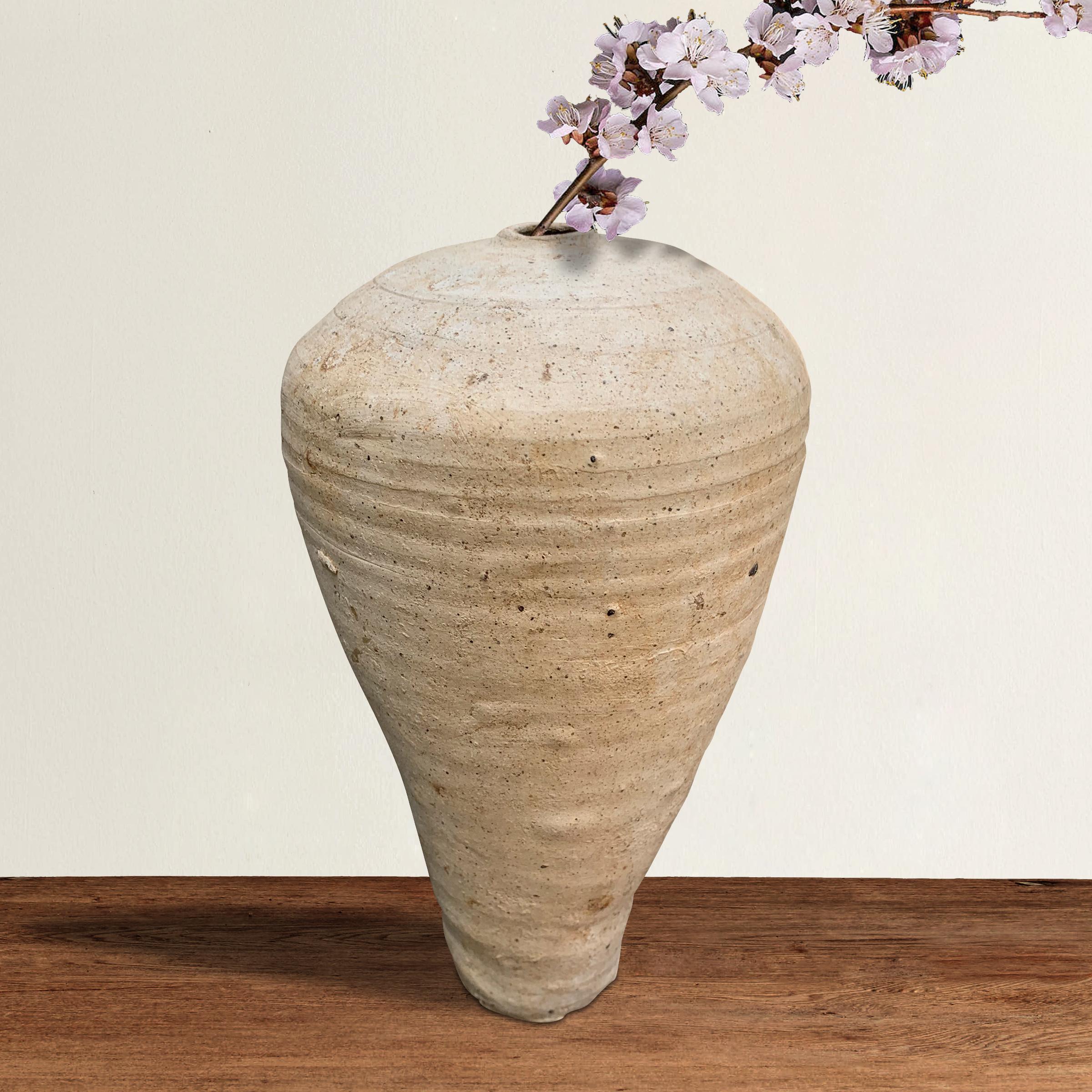 An incredible Chinese Song Dynasty (960 to 1279 AD) hand-thrown ceramic meiping vase of wabi-sabi form with dimples and a perfectly imperfect lean. Meiping vases were designed with the ideal feminine form in mind with a small mouth, large bosom,