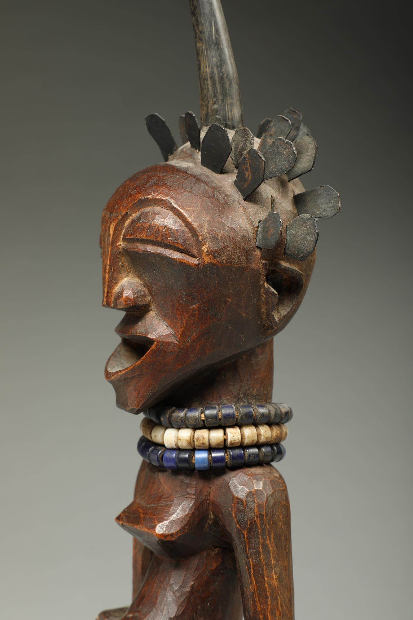 Congolese Songye Female Wood Figure with horn and brass hair ex Sothebys   For Sale