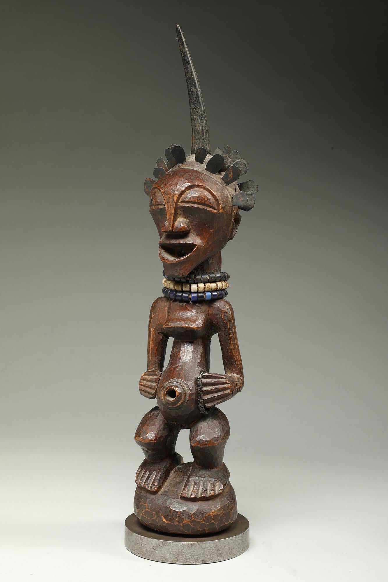 Songye Female Wood Figure with horn and brass hair ex Sothebys   In Distressed Condition For Sale In Point Richmond, CA