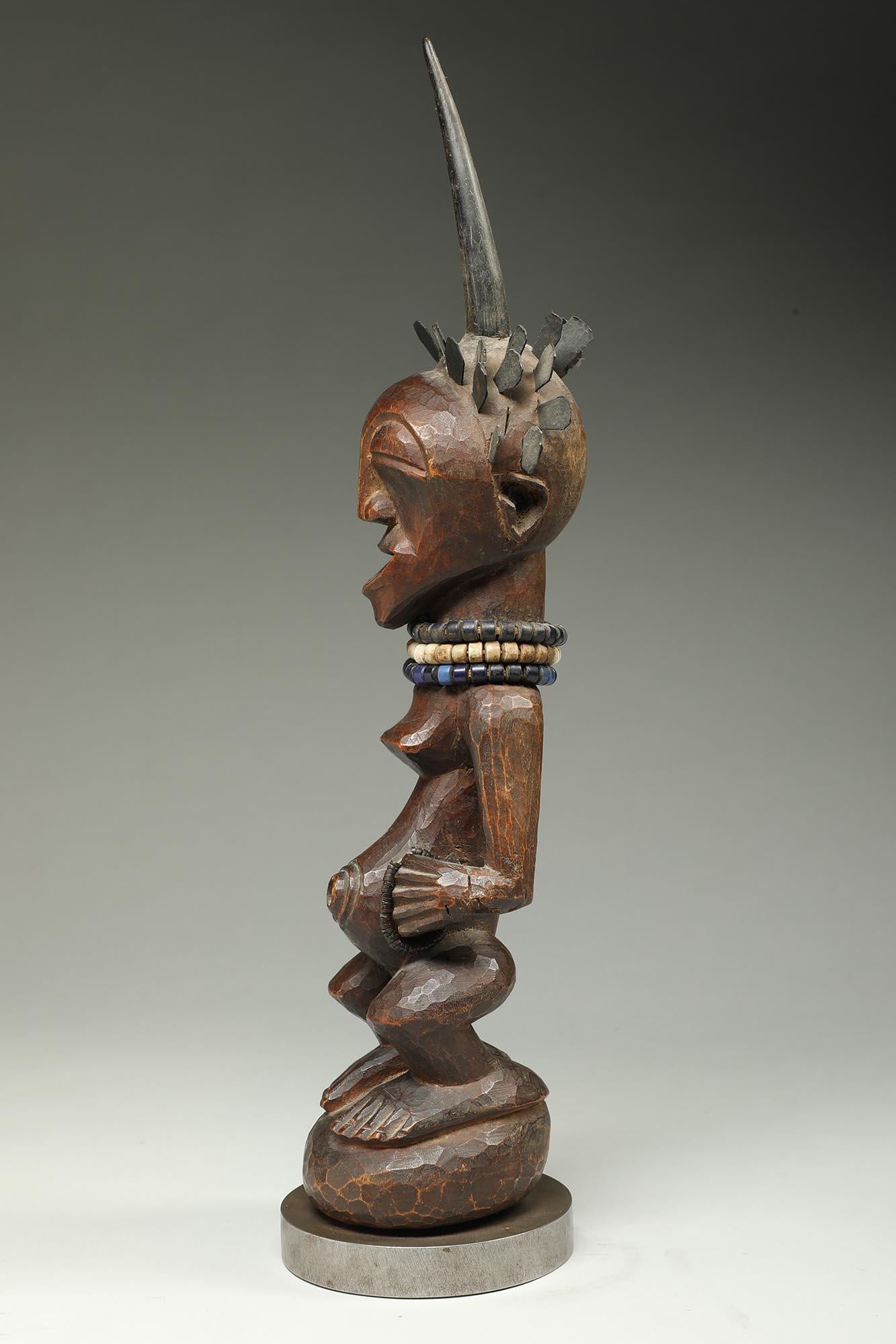 20th Century Songye Female Wood Figure with horn and brass hair ex Sothebys   For Sale
