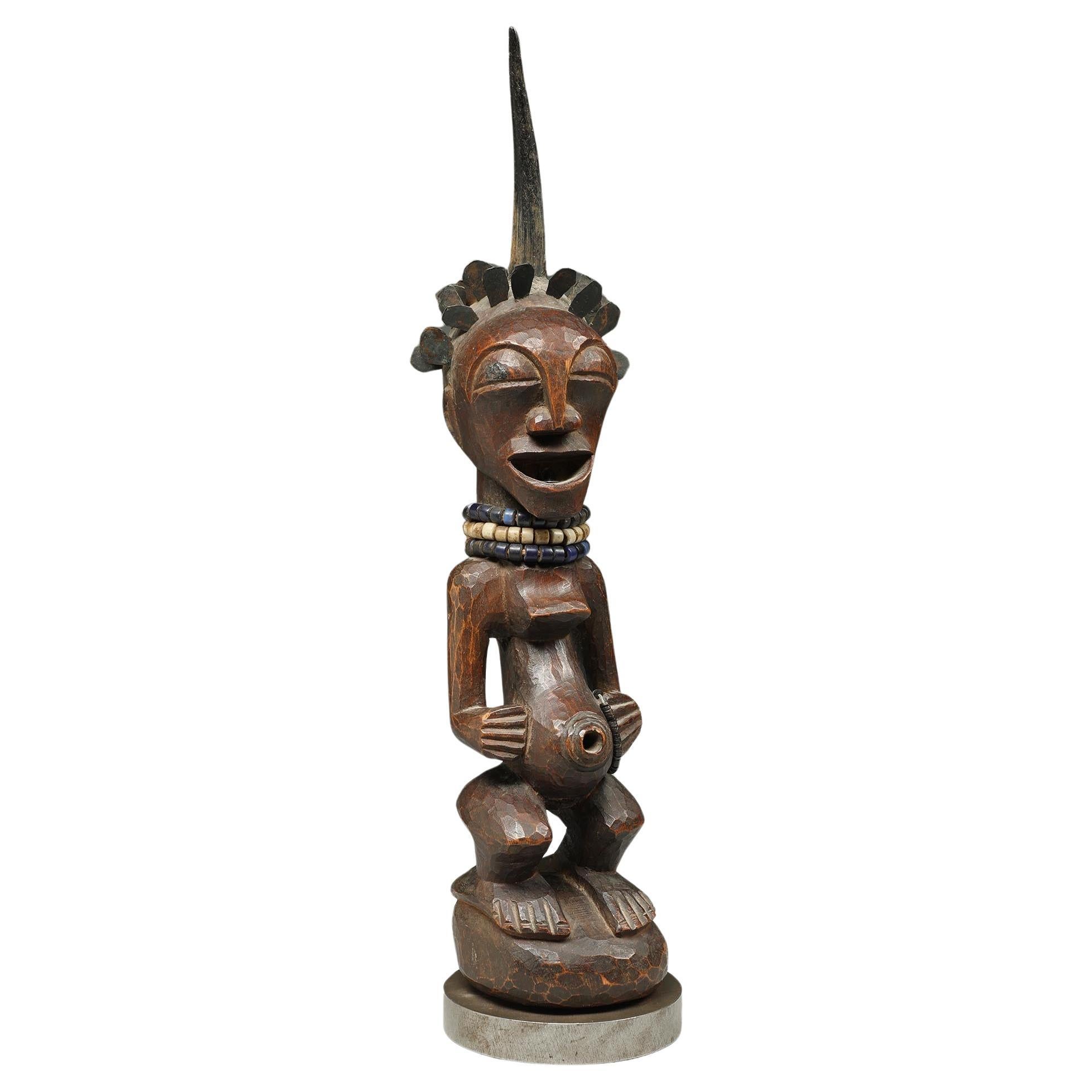 Songye Female Wood Figure with horn and brass hair ex Sothebys  