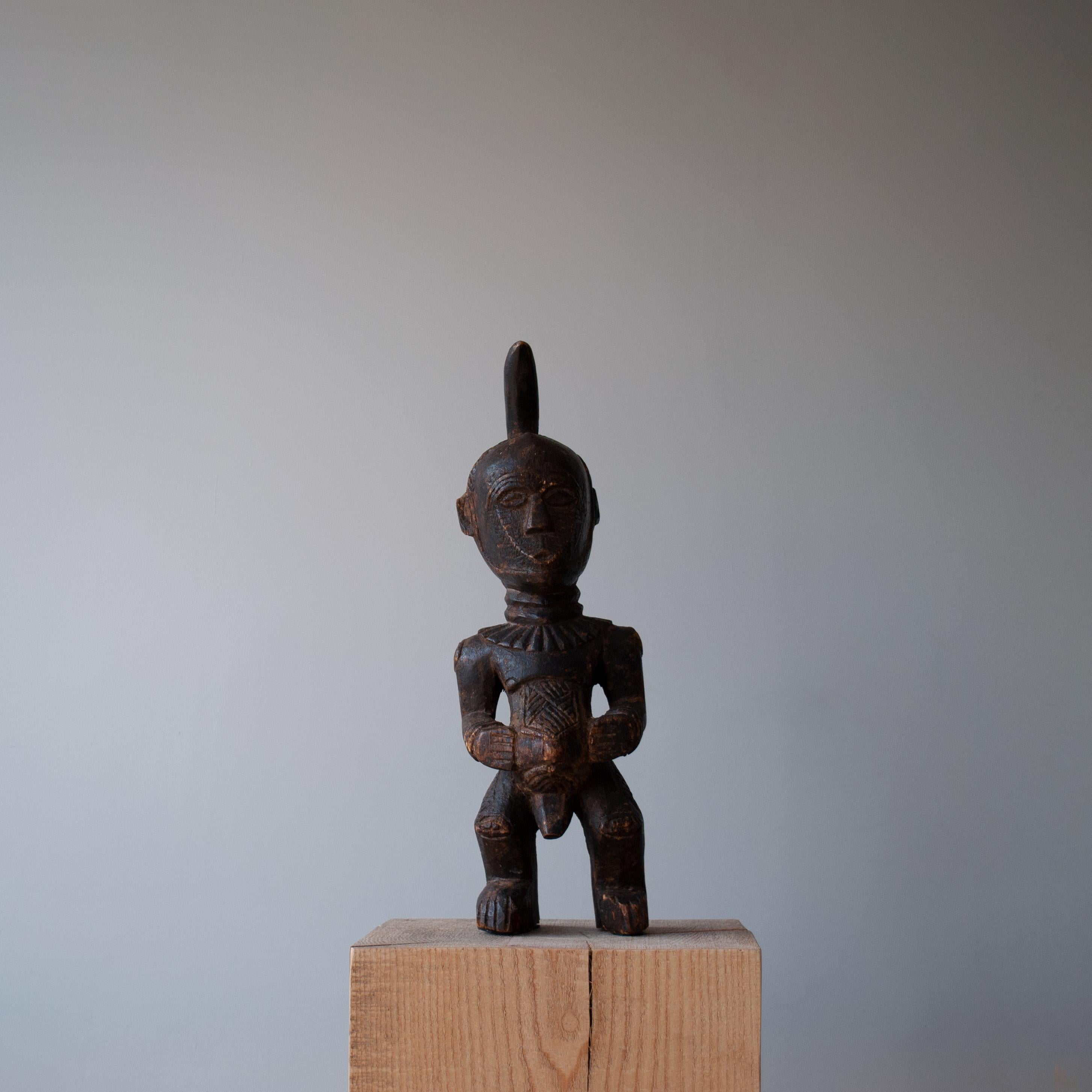 A rare and large hand carved horned Songye Nkisi power figure. A ‘Nkisi’ is a protective power figure of the Songye, southeastern Congo. Such sculptures are used as a major role in the healing of the sick, administration of justice, and other magic