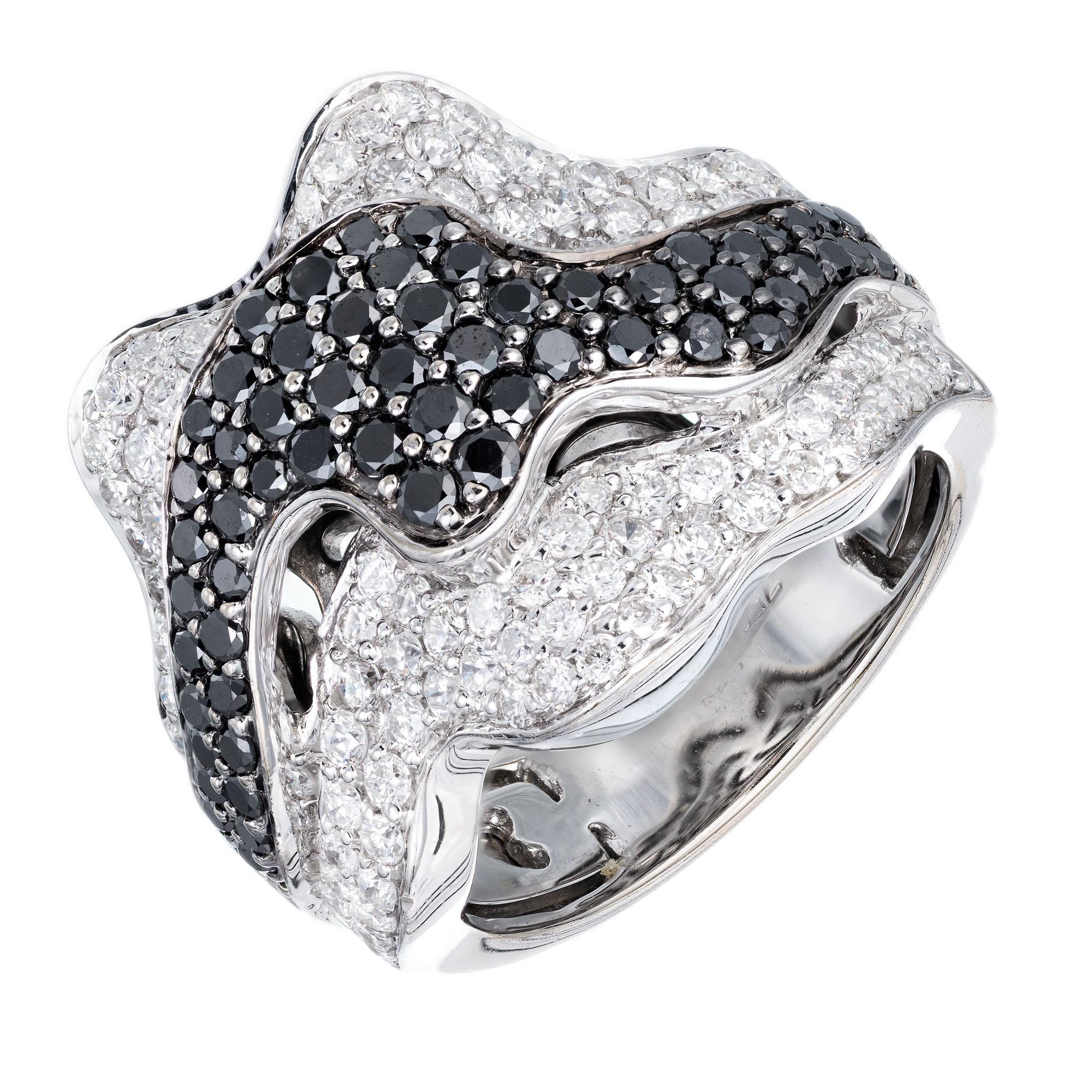 Sonia B white and black diamond cocktail ring set in 18k white gold ribbon design.

62 round black diamonds, approx. total weight .75cts
100 full cut round diamonds approx. total weight 1.25cts, G, VS
Size 6 and sizable
18k White Gold
Stamped: 750