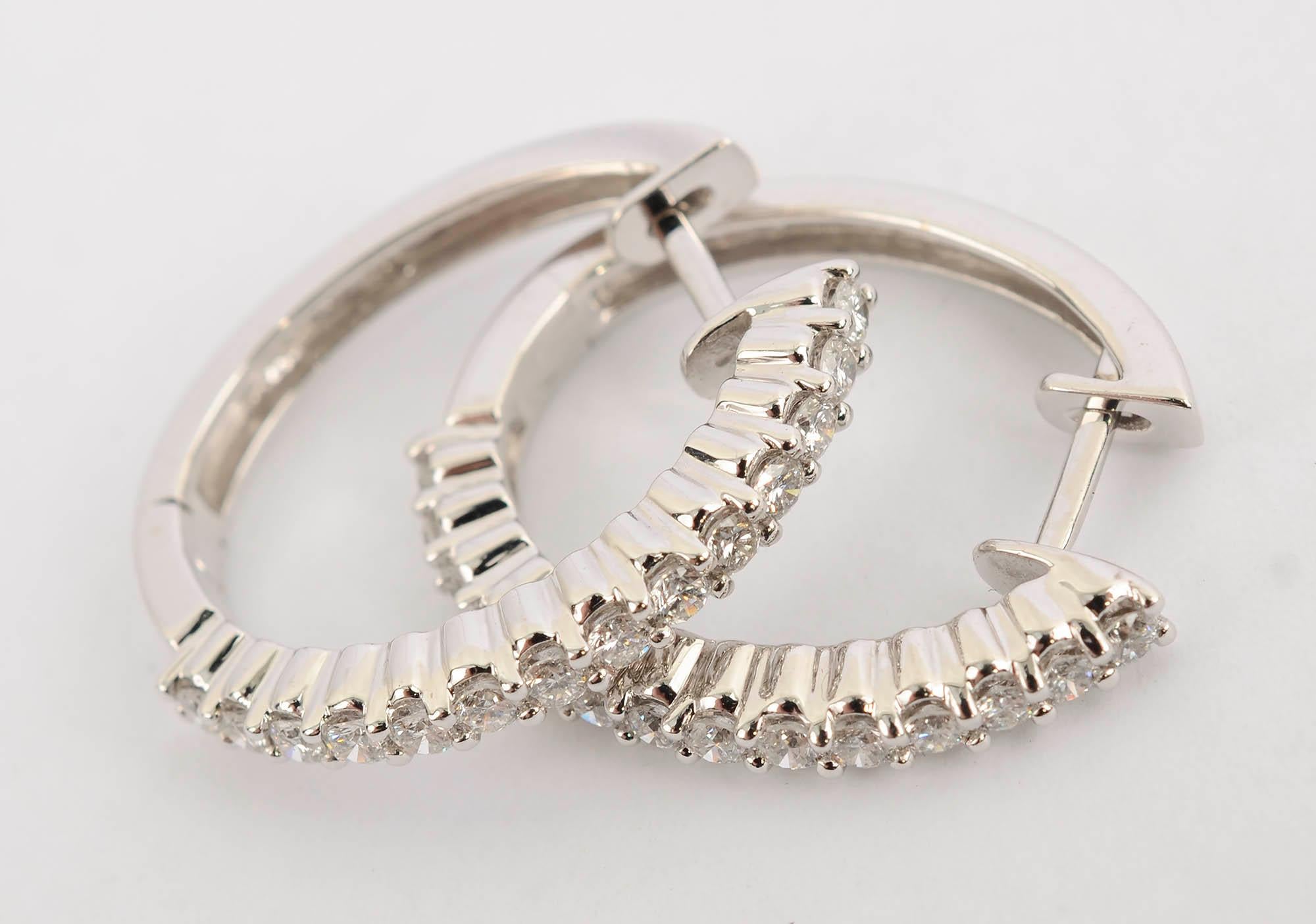 Chic oval hoop earrings by Sonia B are made of 14 karat white gold. The front is covered with 14 diamonds of H color; VS- SI quality The diamonds weigh a total of approximately 1.1 carats. Backs are posts. The earrings are one inch long and 7/8 inch
