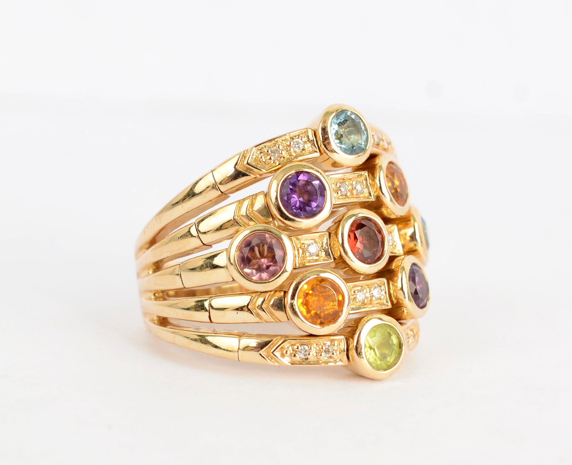 Fashionable ring by Sonia B with five bands that merge as one on the shank. The ring has nine stones that include: amethyst; citrine; peridot; blue topaz and tourmaline. Between the stones are diamonds for some added sparkle. The ring is size 6 3/4