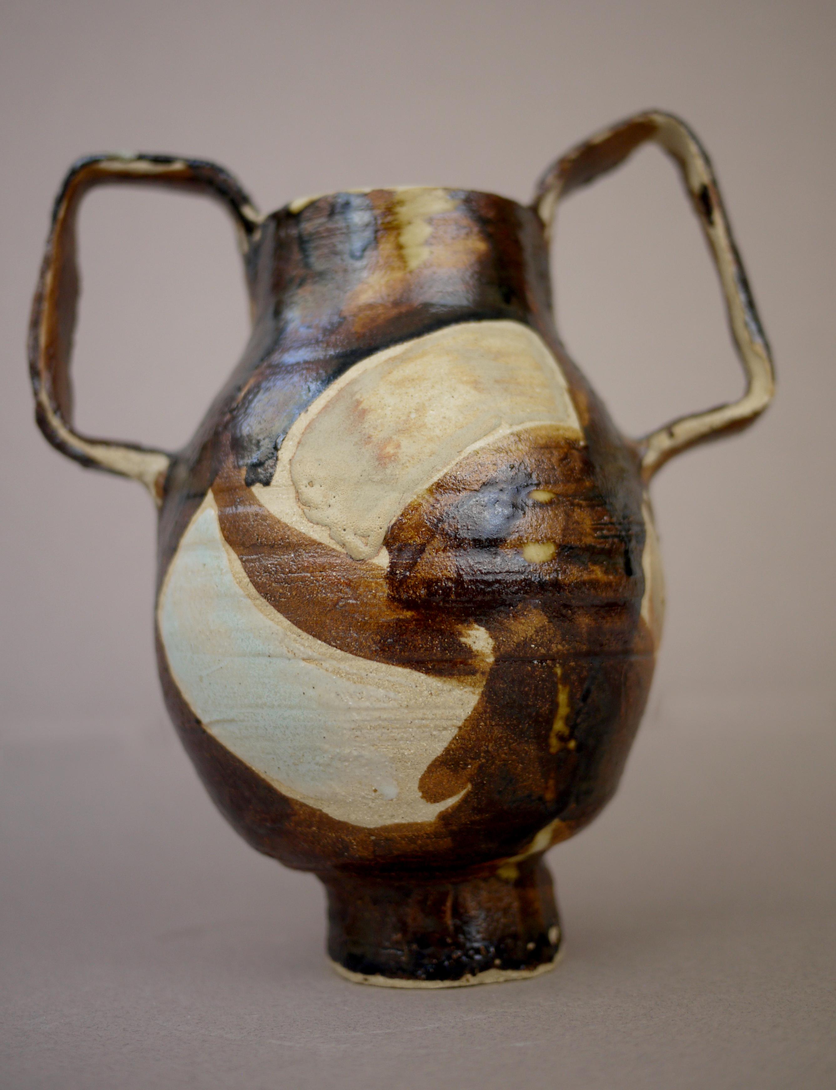 With its distinctive handles and bold brush strokes, this hommage to French artist Sonia Delaunay marked the beginning of a decorative period in Teste’s work. The colors are typical of her palette - oil spot Song era black glaze, matt sand, delicate