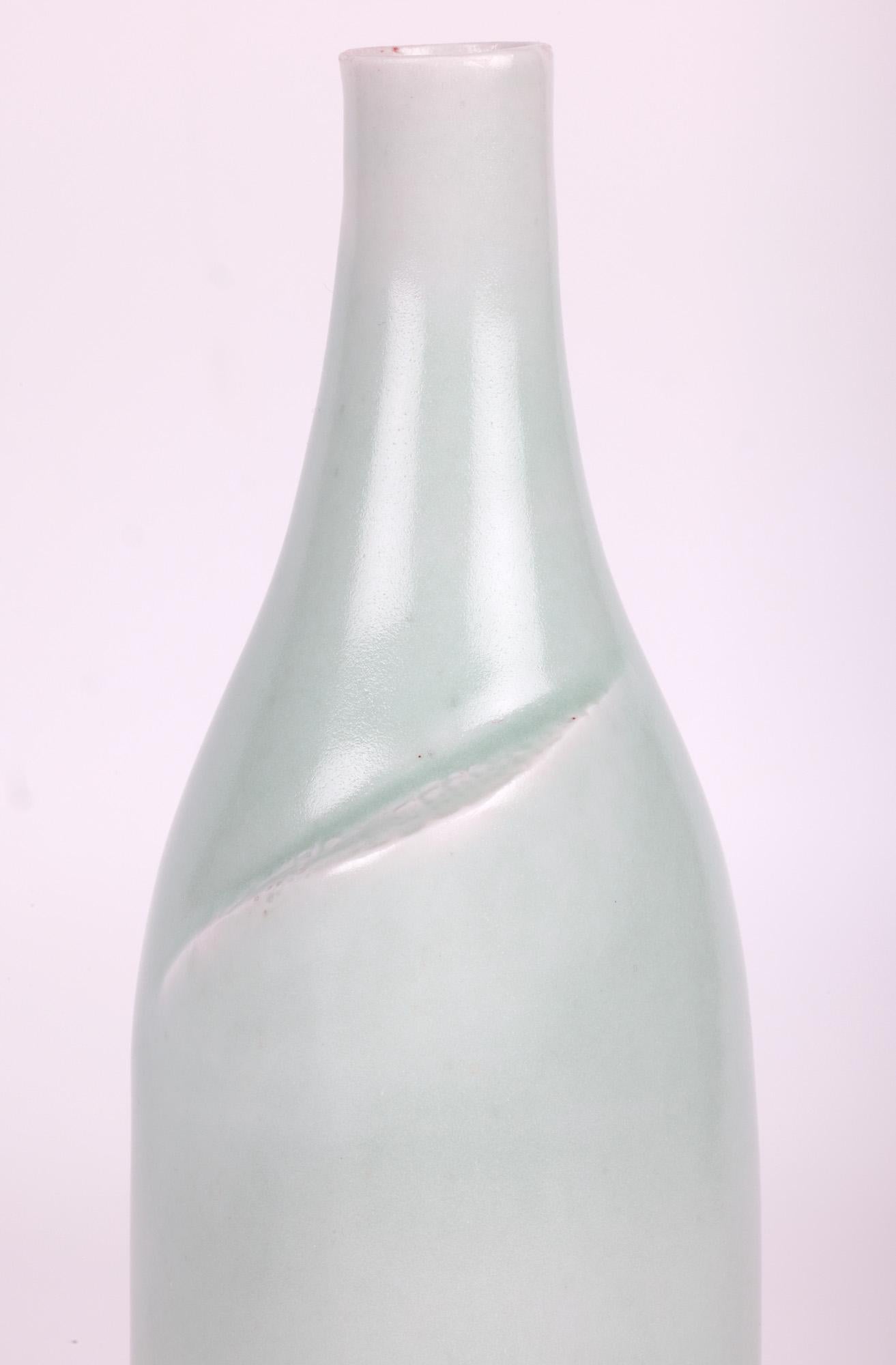 A stunning studio ceramic porcelain bottle shaped vase decorated in celadon green glazes by renowned Cambridgeshire based potter Sonia Lewis acquired from a large collection and believed to date from the latter 20th century. This finely potted vase