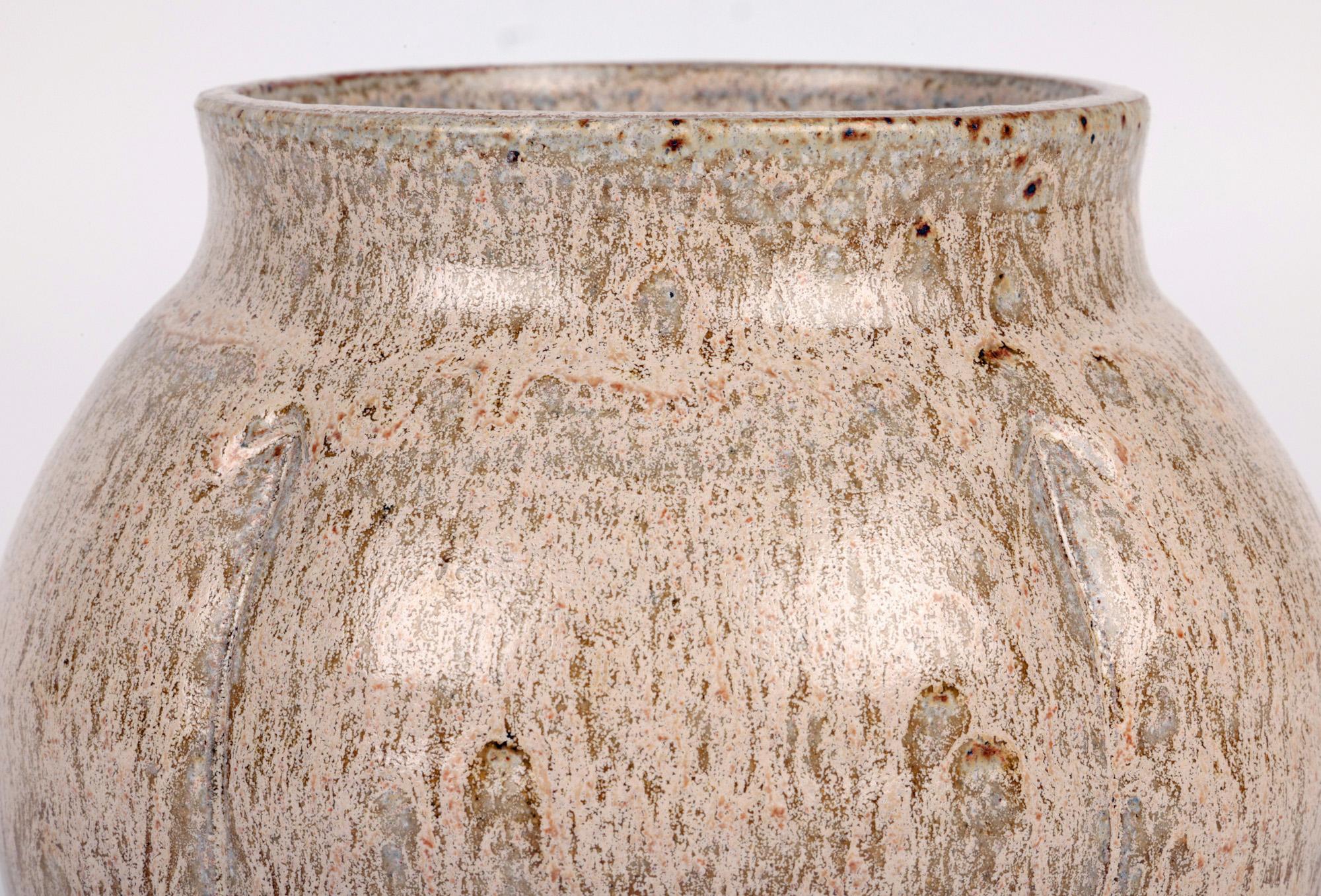 A stunning studio pottery oatmeal glazed vase by renowned Cambridgeshire based potter Sonia Lewis acquired from a large collection and believed to date from the latter 20th century. This finely potted stoneware vase stands on a wide round unglazed