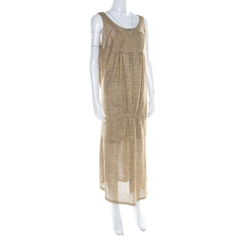 Sonia Rykiel never fails to impress us and charms us yet again with this fabulous maxi dress! The beige creation is made of a wool blend and features a perforated lurex knit design. It flaunts a gathered silhouette and comes with a scooped neckline