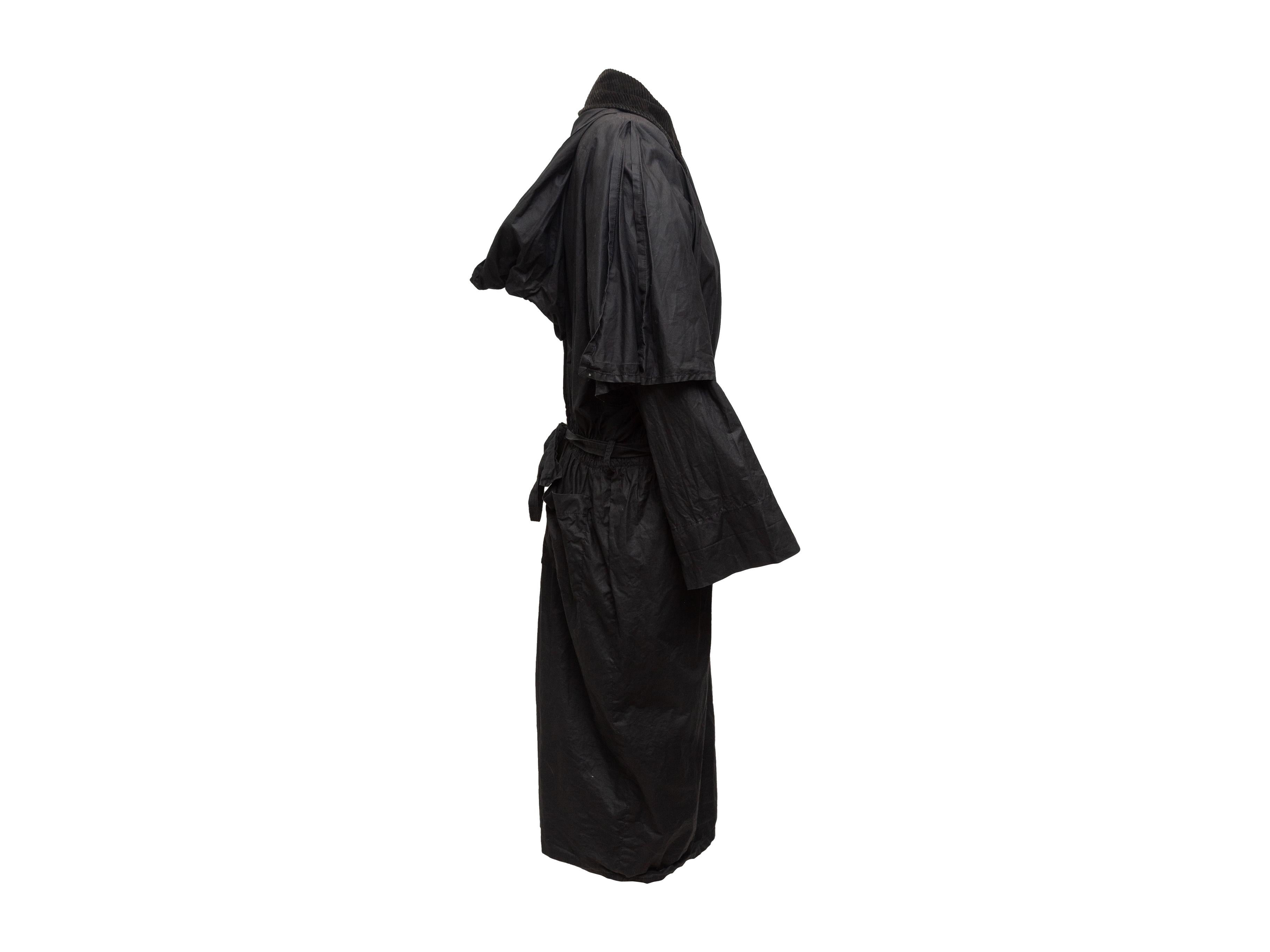 Product details: Vintage black coated cotton hooded coat by Sonia Rykiel. Corduroy pointed collar. Dual back pockets. Sash tie at waist. Closures at front. 25