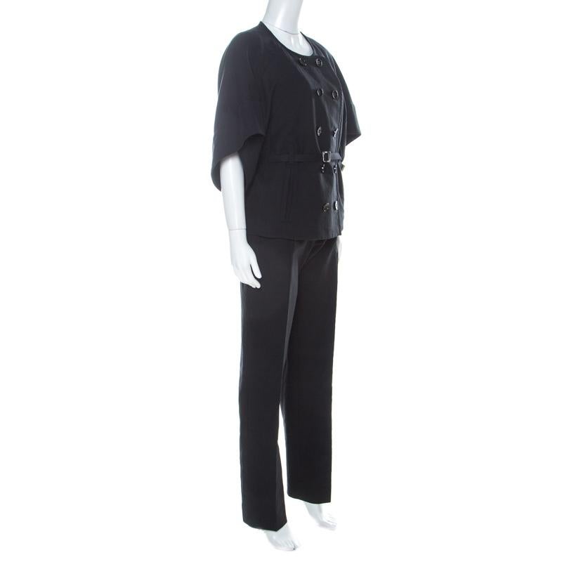 Nothing gives you a better style than a well-designed pantsuit. This one from Sonia Rykiel is a classic creation meant to elevate your formal look. Cut from black cotton, the belted blazer features a round neckline with a double-breasted silhouette,