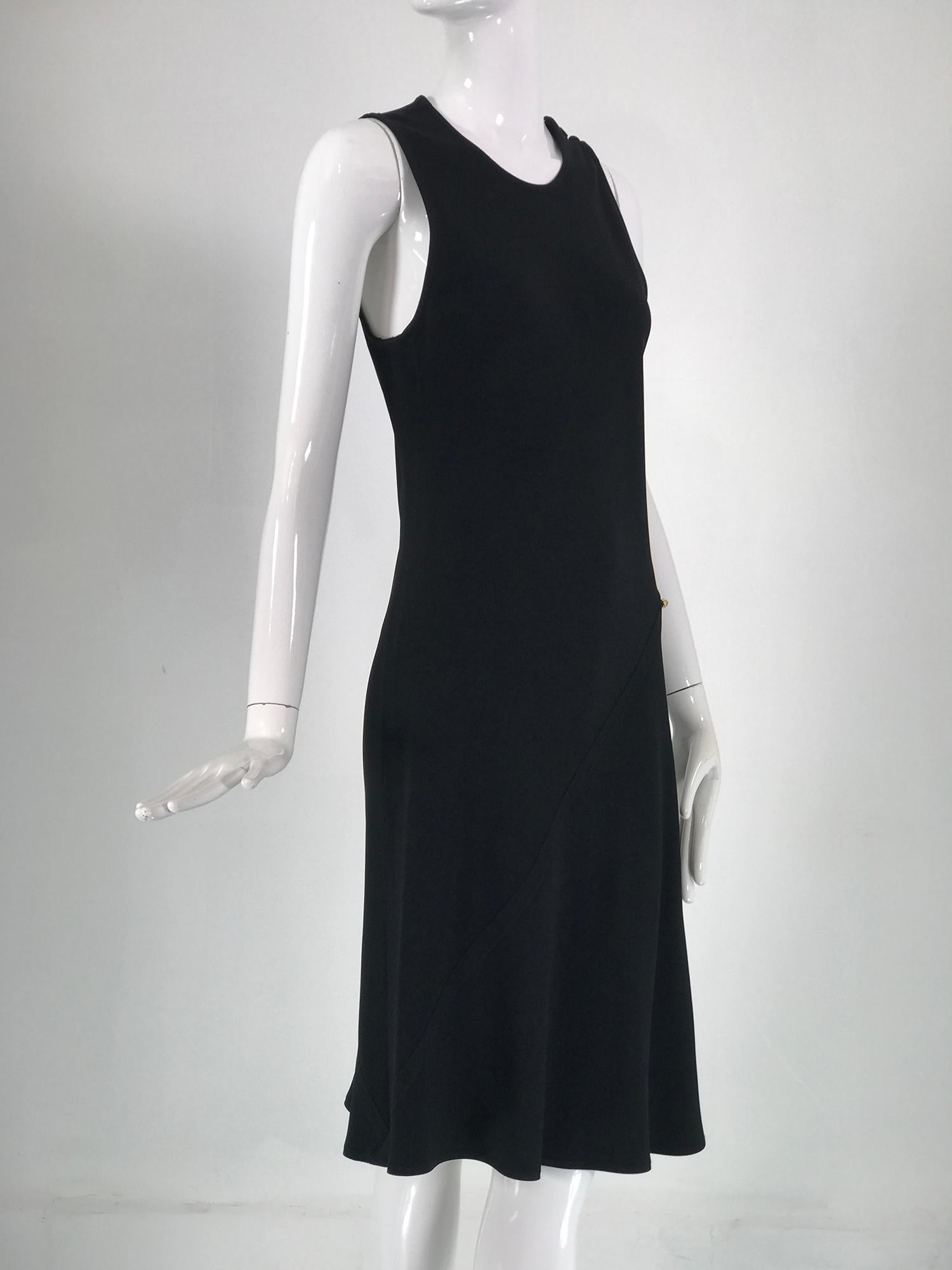 Sonia Rykiel black satin backed crepe bias cut, sleeveless dress. Jewel neck dress slips on closing at the shoulder with 3 self buttons. Deep arm openings. Two flat felled bias seams at front and back from hip to hem. There is a single rhinestone