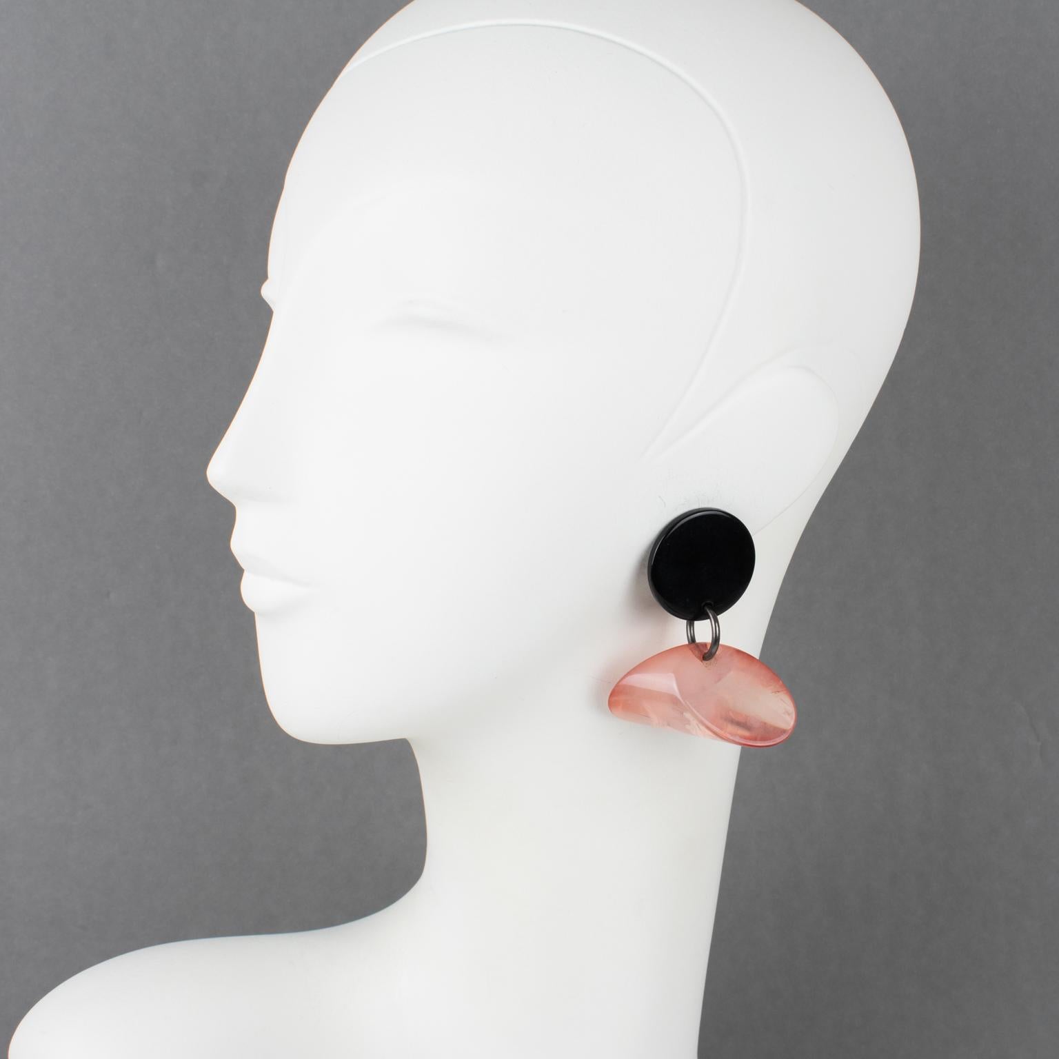 These so chic French fashion designer Sonia Rykiel Paris dangling clip-on earrings feature a geometric shape with a black acrylic resin disk complemented with dimensional triangle resin in powder pink marble color. They are signed underside with the