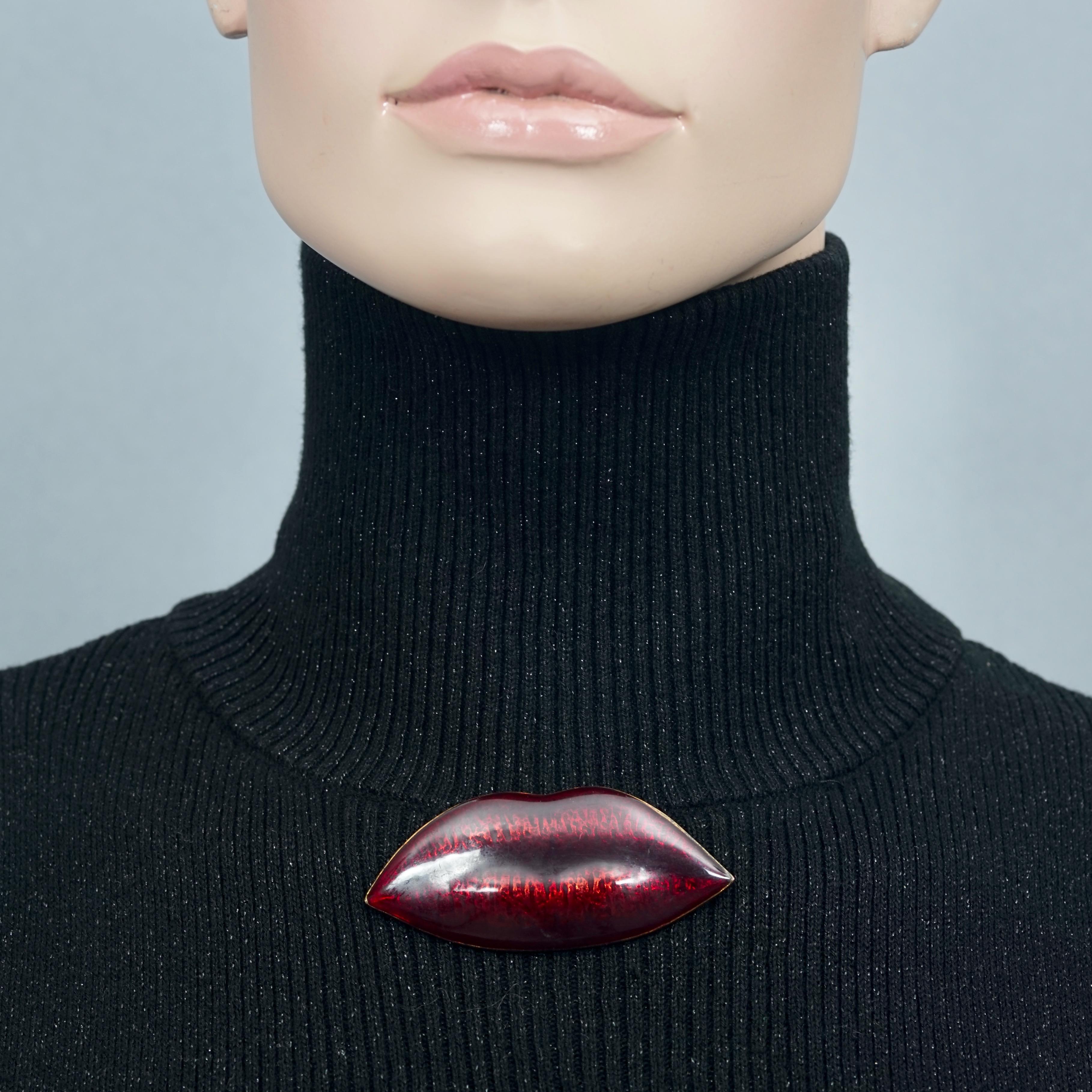 SONIA RYKIEL “Kiss Me” Sultry Red Lips Brooch

Measurements:
Height: 1.26 inches (3.2 cm)
Width: 2.80 inches (7.1 cm)

Features:
- 100% Authentic SONIA RYKIEL.
- Enamel sultry red lips brooch.
- Bronze tone hardware.
- Signed SR.
