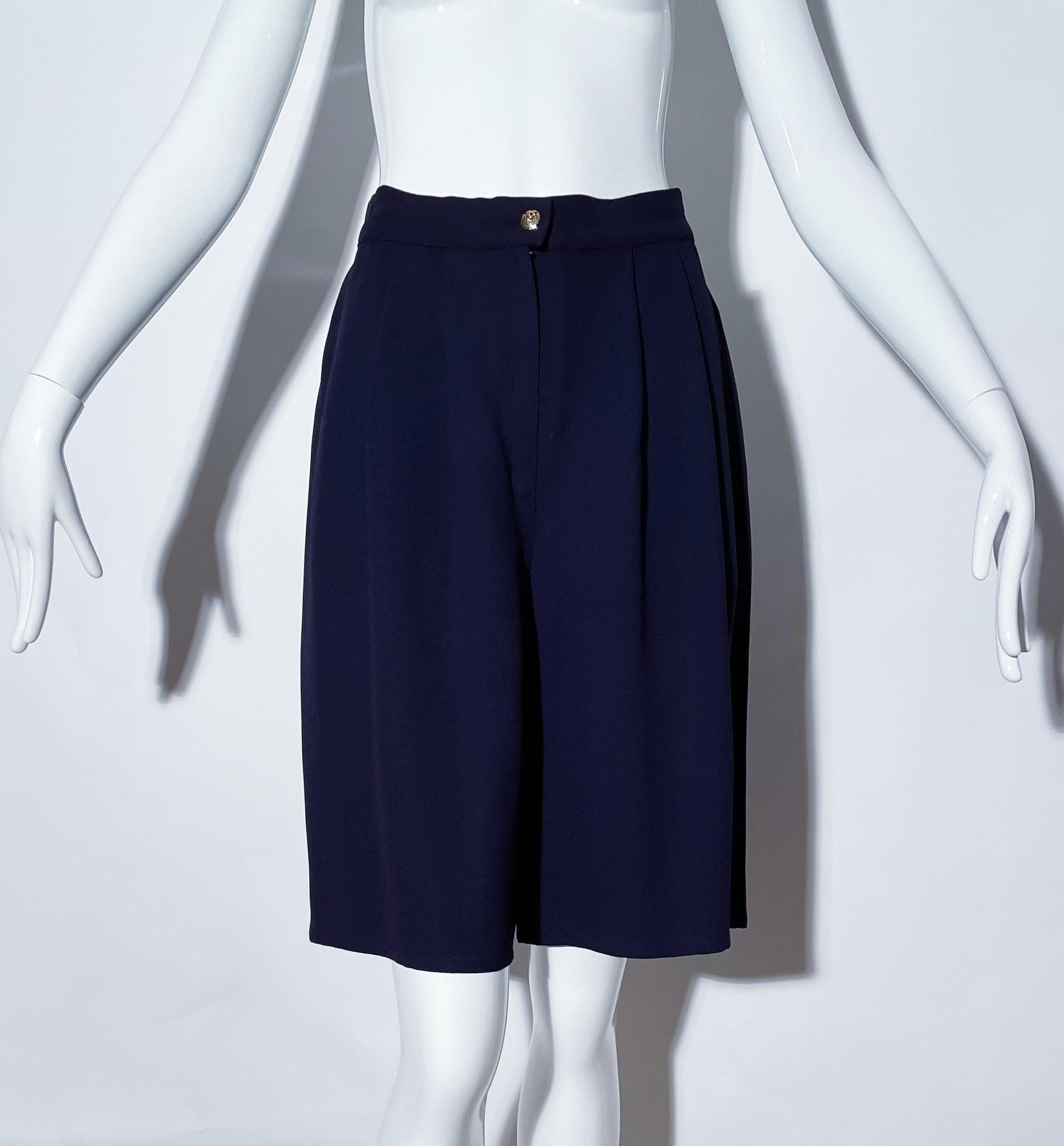 Navy Bermuda shorts. Front pleats. Front pockets. Front zipper closure. Acetate and rayon. Made in France. 
*Condition: excellent vintage condition. No visible flaws.

Measurements Taken Laying Flat (inches)—
Waist:  28 in.
Hip: 42 in.
Rise: 13
