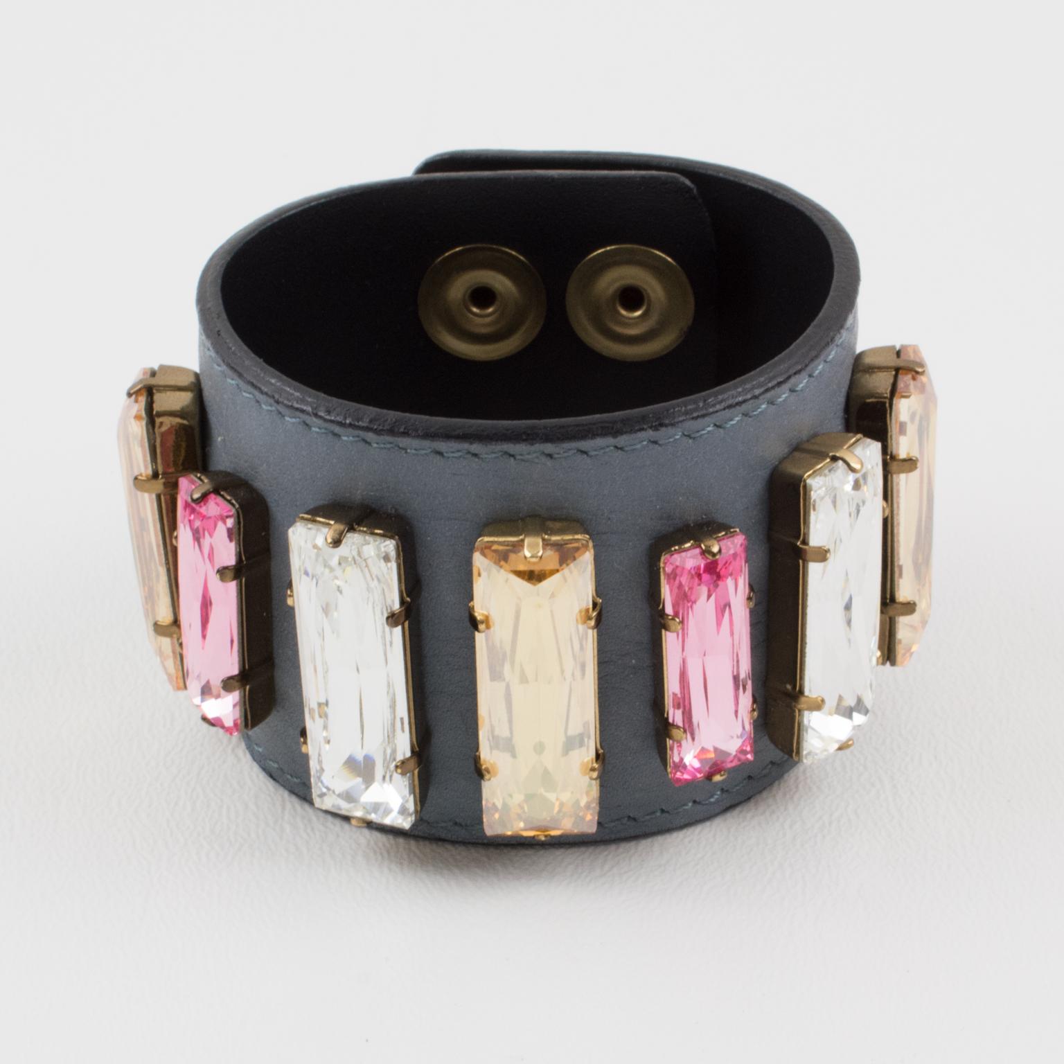 Sonia Rykiel, Paris, designed this charming leather belt bracelet. It features an oversized, stitched, mouse-gray leather large band, ornate with pastel-colored crystal rhinestones in an assorted, long stick shape. The bracelet features clear