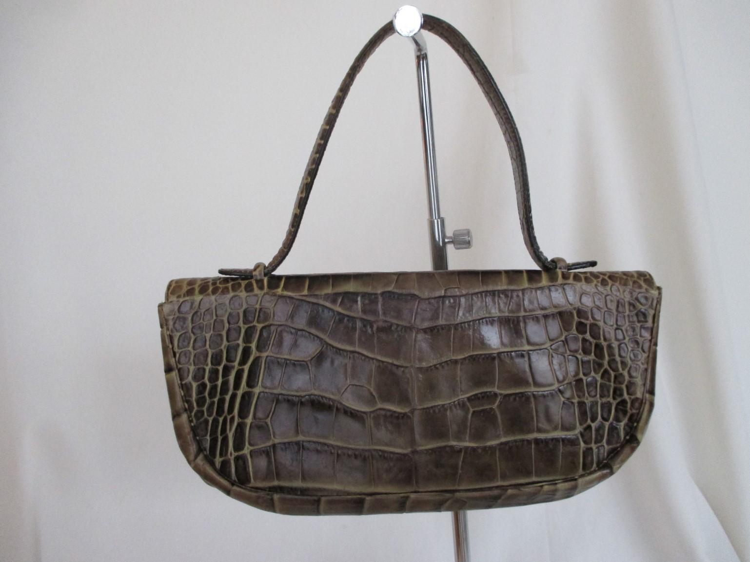 Classic vintage Sonia Rykiel embossed leather bag.
- edgy and chic
It closes with a magnetic press stud
one pocket inside.
The bag is worn has some spots inside lining and on bucket.

Dimensions aproxx: 
width 29 cm/ 11.41 inch 
height 14 cm/ 5.51