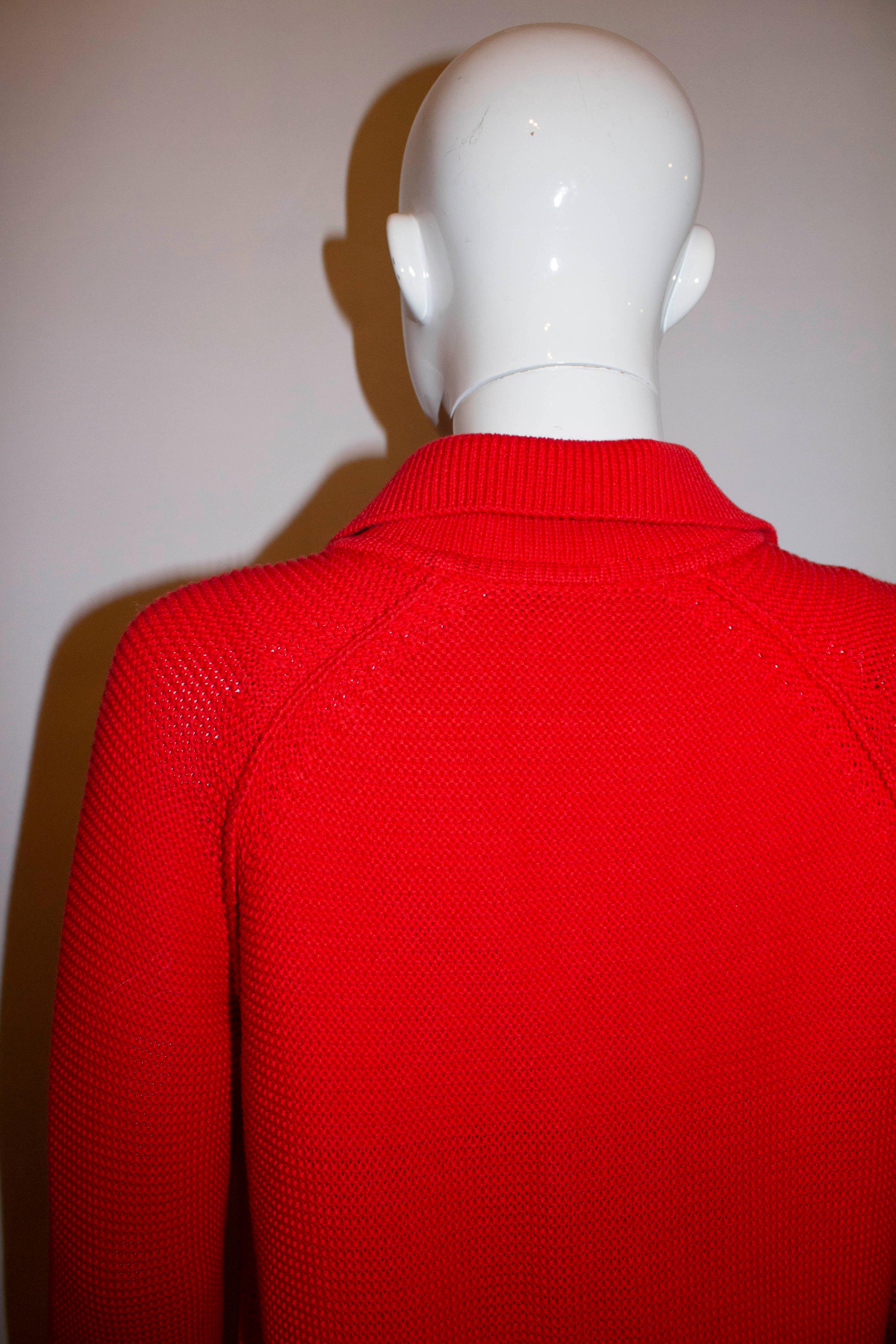 A chic and colourful coverup for Spring /Summer. By Sonia for Sonia Rykiel, the cardigan is in red cotton with a red silk trim. It has turn back cuffs, pockets at hip leval and a button front opening.
Measurements : Bust 37'',length 31''