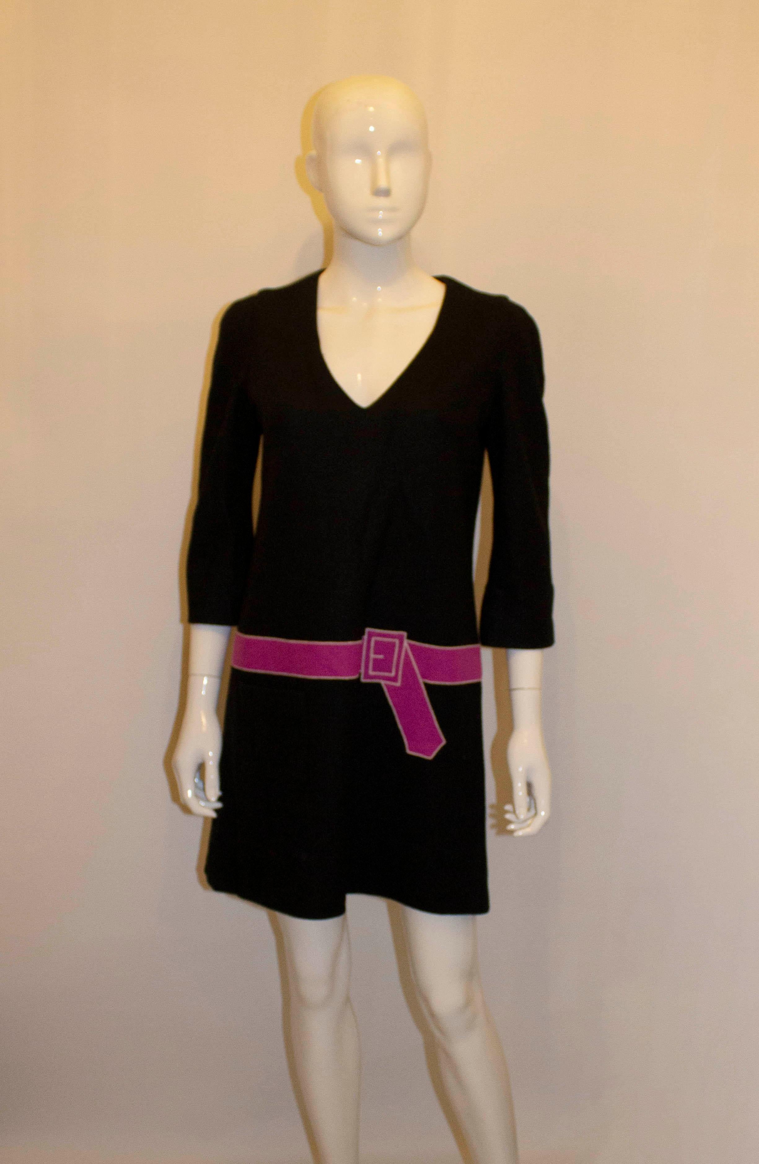 A fund and easy to wear dress by Sonia Rykiel, Sonia line. The wool dress has a v neckline, central back zip opening and a pink fake belt. It is fully lined and has a pocket on the left hand side.  Size 40 Measurements: Bust 37'', length  34''
