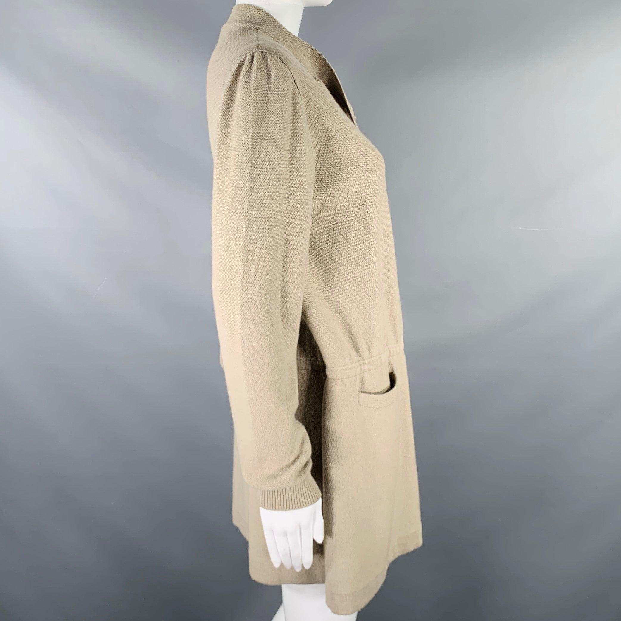 SONIA RYKIEL cardigan
in a
taupe beige knit featuring a dropwaist style with belt, two pockets, and an asymmetrical button closure.
Made in Italy.Very Good Pre-Owned Condition. Minor mark above left pocket. 

Marked:   36 

Measurements: 
