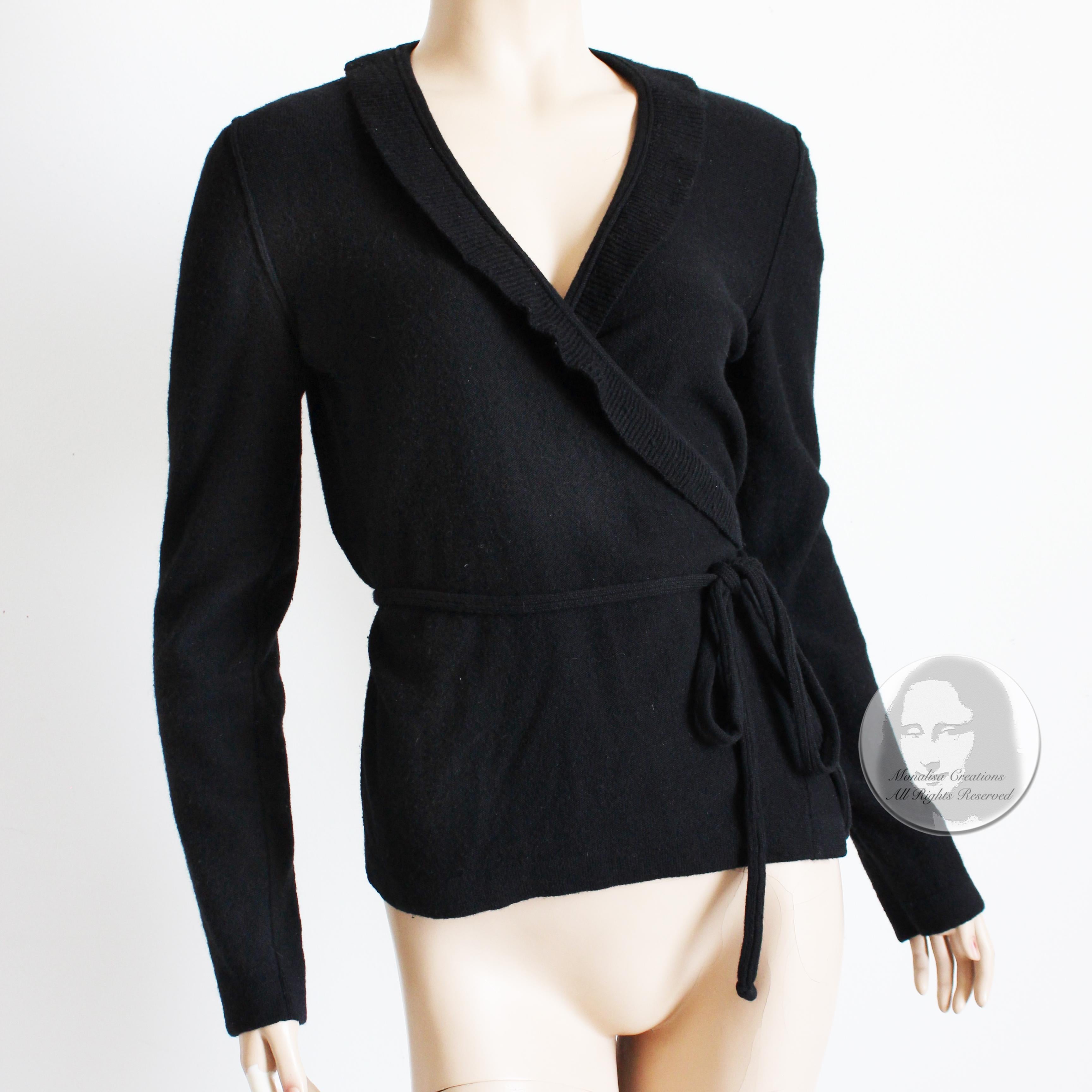 Preowned, vintage wrap style cardigan sweater by Sonia Rykiel Paris, likely made in the 90s. Made from a black wool and angora knit, it fastens wrap style with skinny knit ties.  

Simple, chic and elegant - a hallmark of the designer! Wear this