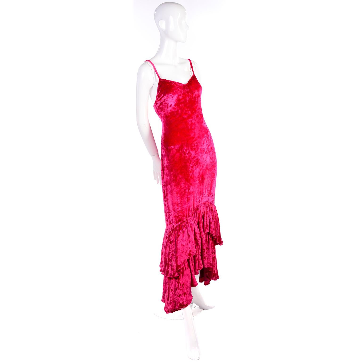 This is a gorgeous raspberry pink crushed velvet Sonia Rykiel vintage dress with a unique double layered ruffled high to low hem. It has spaghetti straps and buttons up the back with velvet covered buttons. It has one smudge in the front, but it is