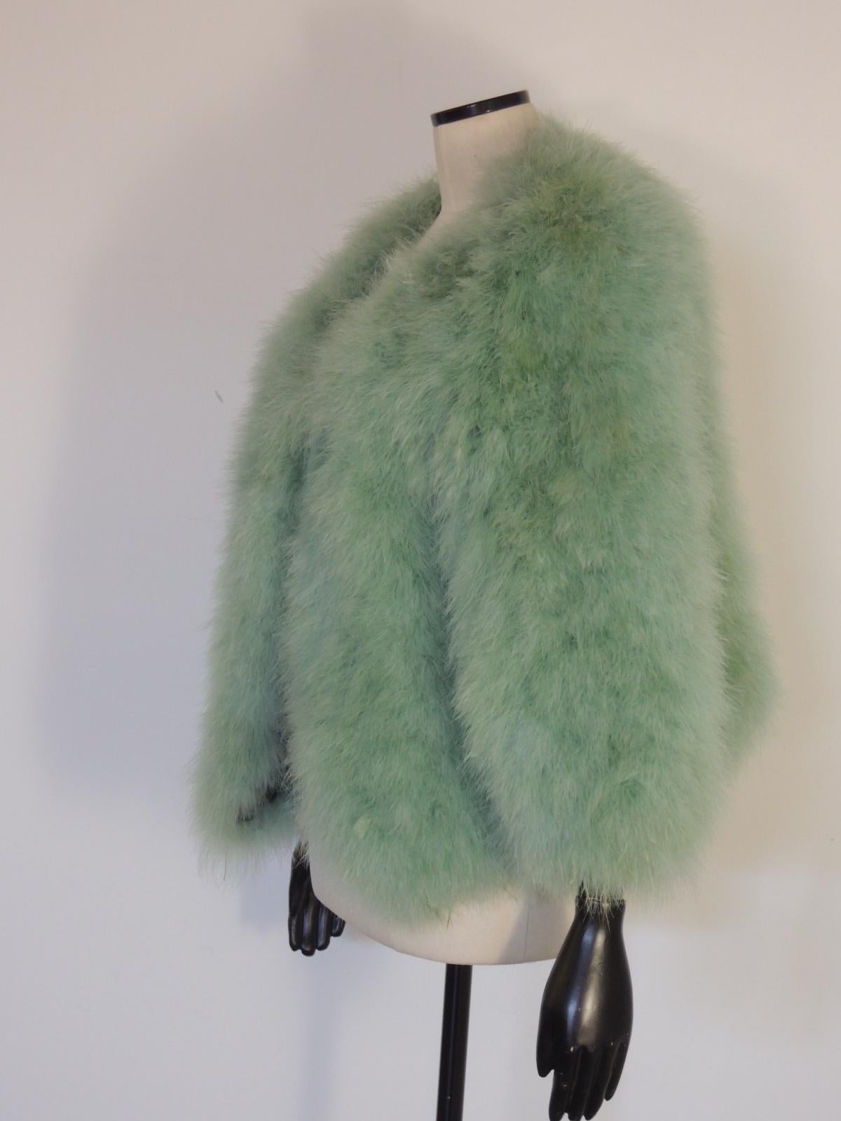 This is an open-front Sonia Rykiel feather jacket in a seafoam green color.

There is no size tag present. 90% turkey feathers, 10% nylon.

This item is in excellent pre-owned condition with no structural defects or stains.

MEASUREMENTS: (taken