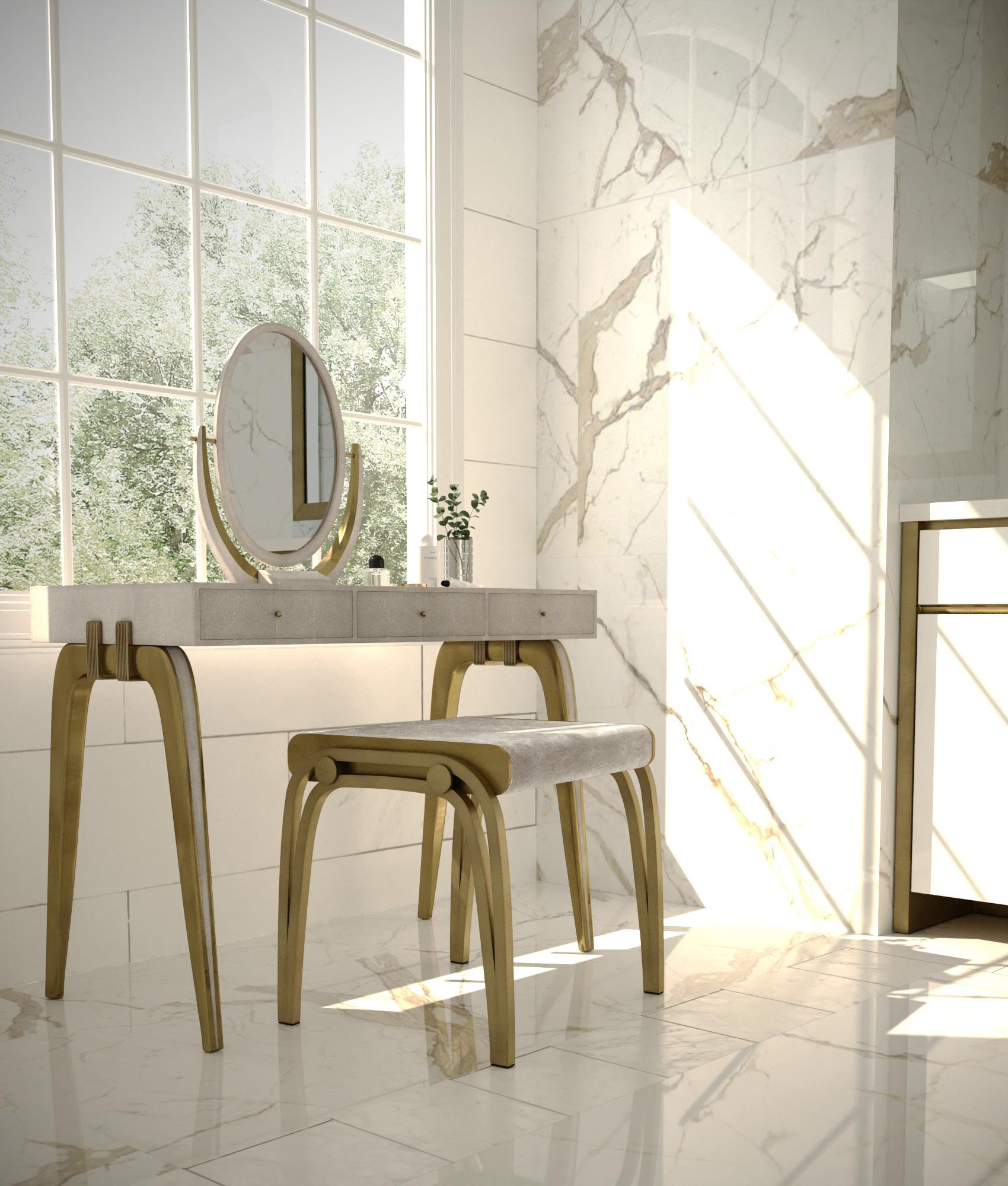 The Sonia vanity set in cream shagreen and bronze-patina brass by R&Y Augousti, is the perfect piece for your bedroom or bathroom. The removable mirror is elegant and the angles can be adjusted. The Victoria stool upholstered in a creamy-taupe