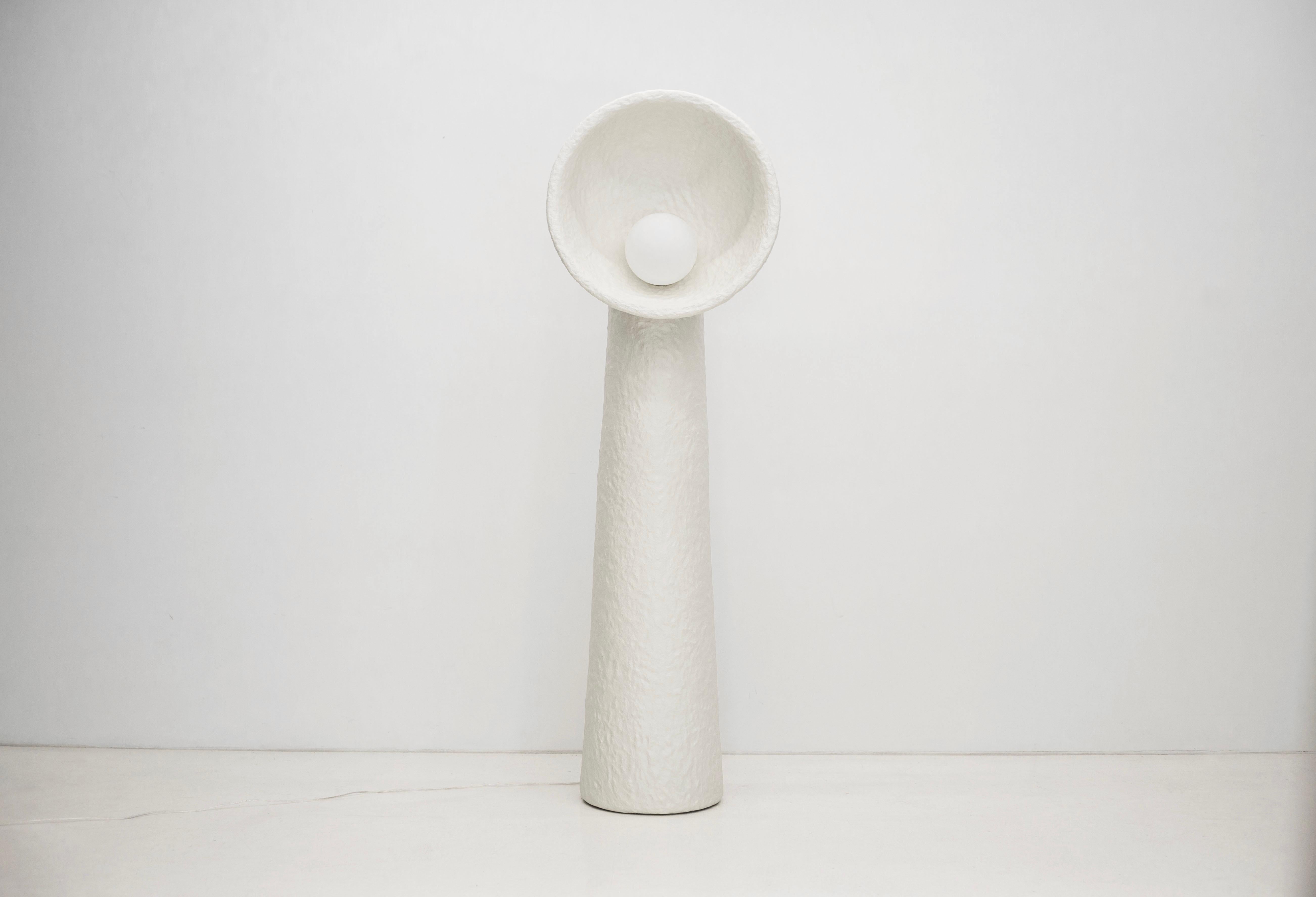 SONIAH / Ukrainian for sunflower / a symbol of prolific Ukrainian earth.

Each floor lamp is crafted by hand in FAINA’s sustainable material — ZTISTA. Sculptural SONIAH lamps stem from the ground, their pure shapes eliminate the excess and shine