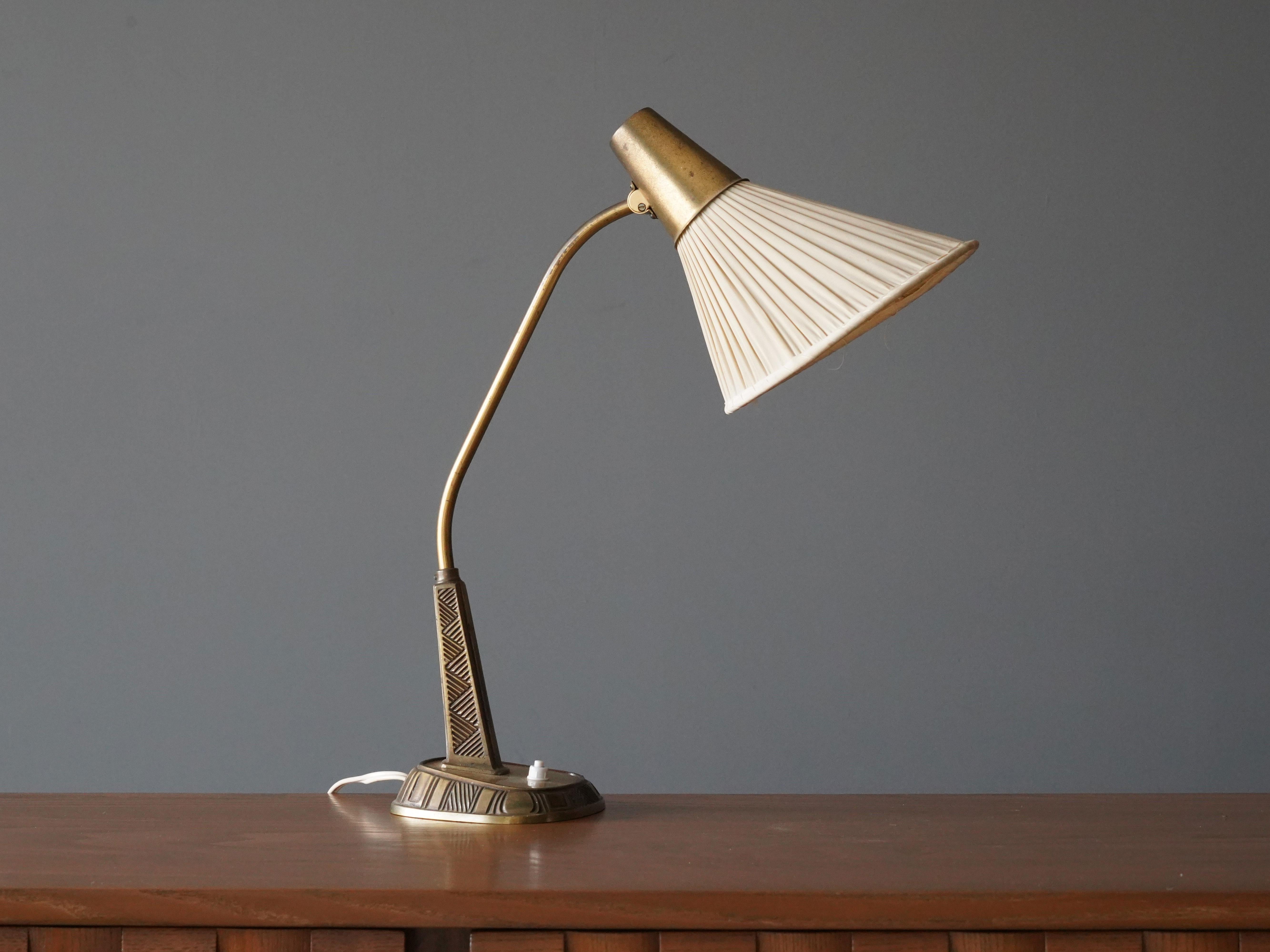 An adjustable table lamp / desk light. Designed by Swedish sculptor Sonja Katzin, (1919-2014). Produced by ASEA, Sweden, 1950s.

Executed in brass, original fabric screen.