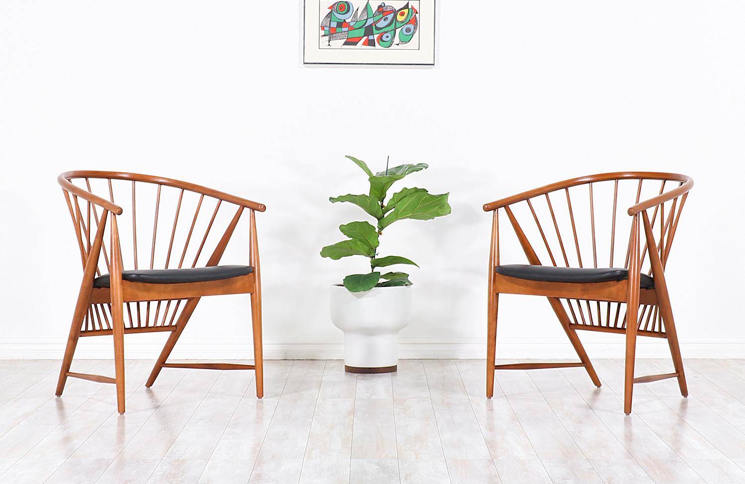 Iconic easy modern chairs designed by Sonna Rosén for Nässjö Stolfabrik in Sweden in 1948. This early example of the “Sun Feather” spindle chairs was inspired by the Shaker design movement showcasing remarkable craftsmanship throughout the chair