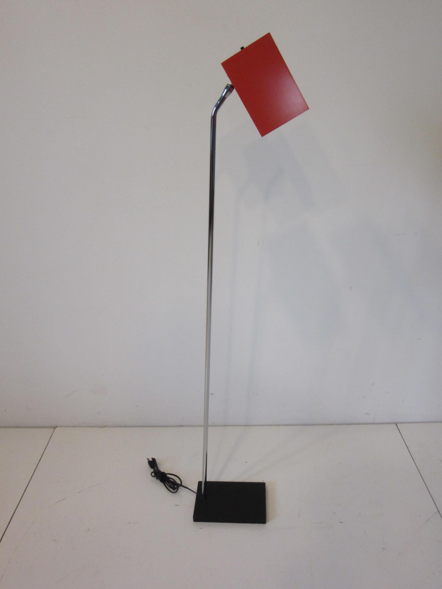 A well crafted floor lamp with heavy satin black steel base and chrome shaft having a medium orange adjustable metal box shade designed by Robert Sonneman for the George Kovacs Lighting Company.