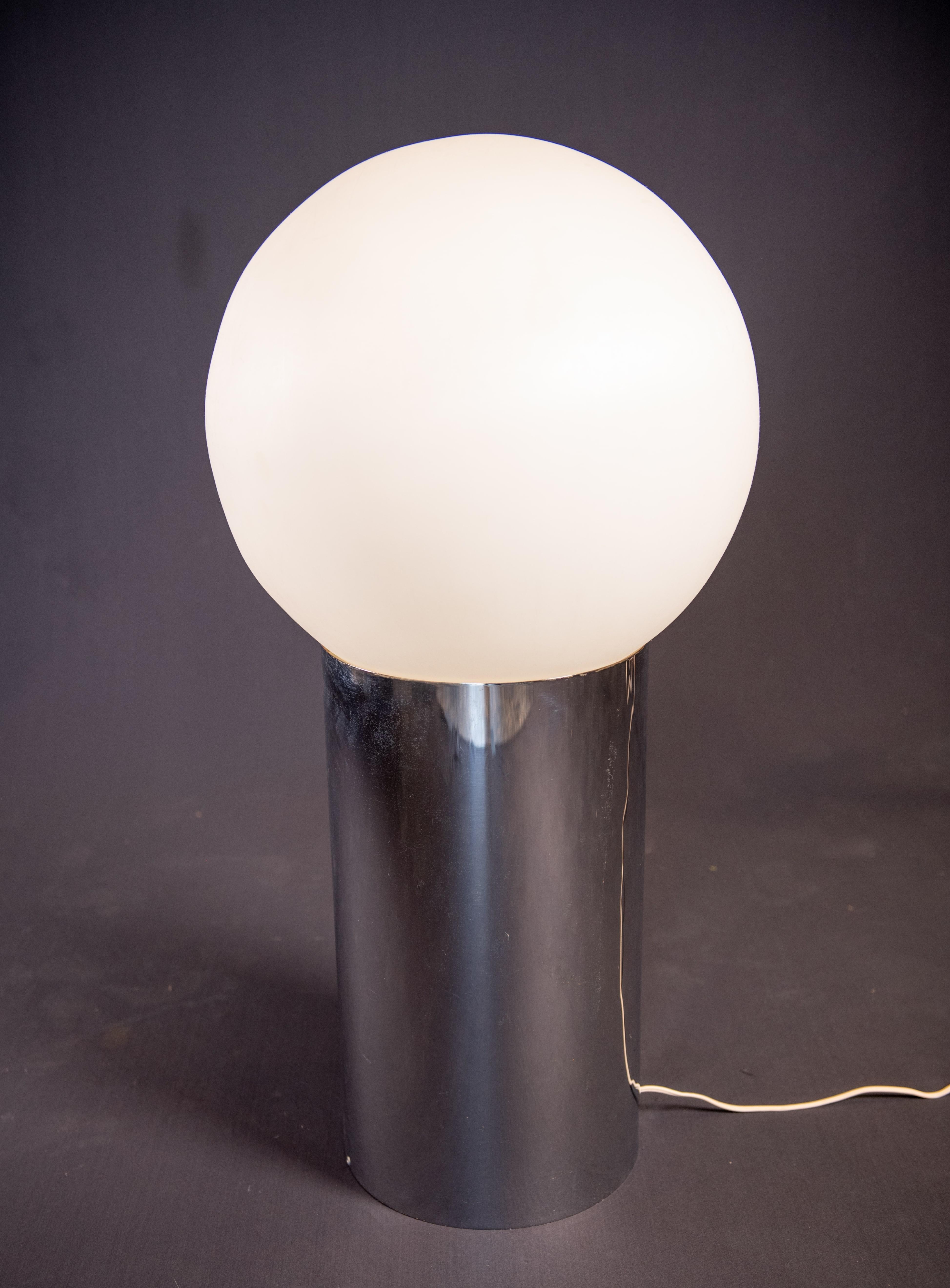 Lamp designed by Robert Sonneman for George Kovacs 1972.  Mirror polished stainless steel cylindrical base with white opal acrylic globe. Switch on base. Takes a single standard edison screw lightbulb. Great statement lamp

Chrome base is 9.5 inches