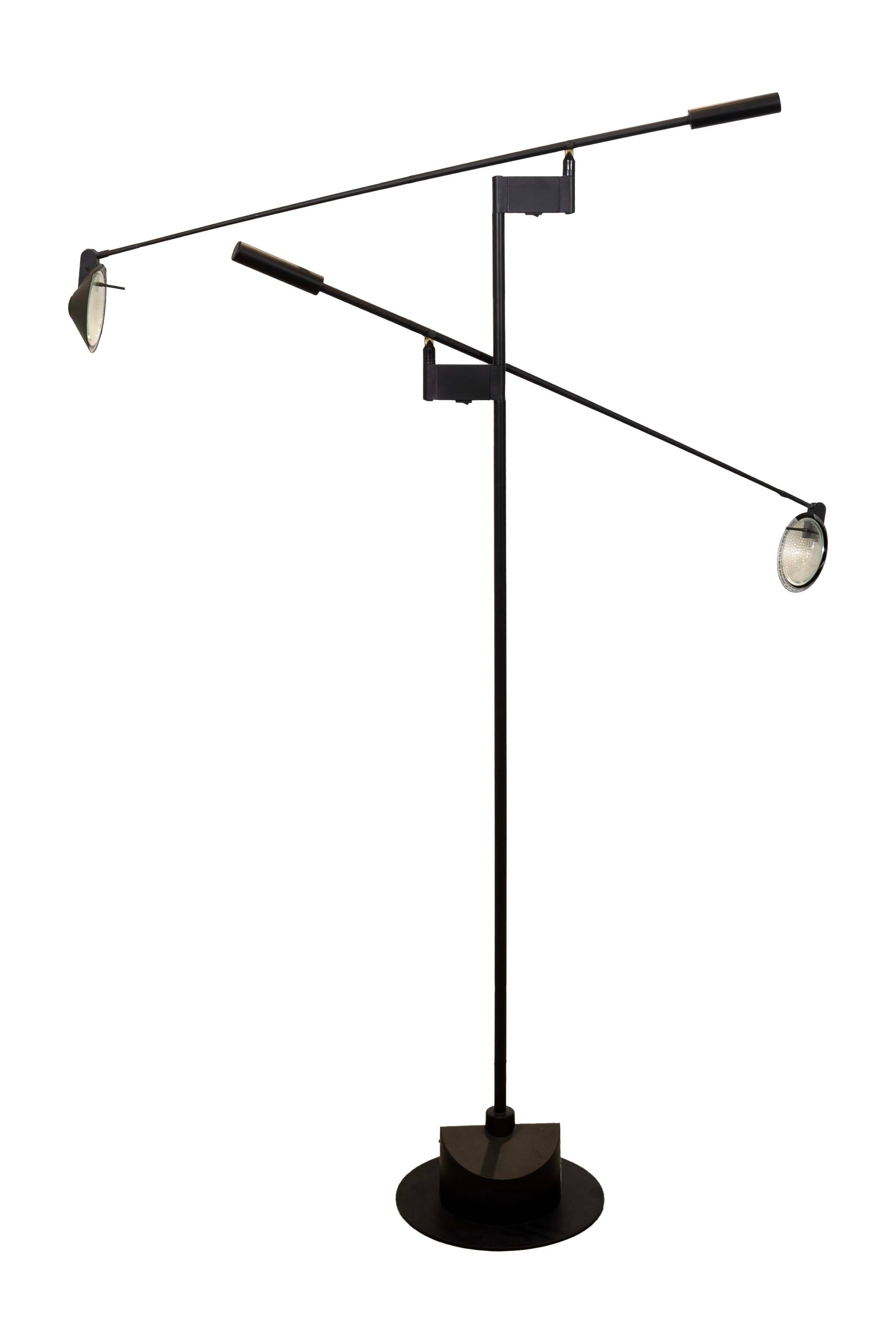 Embrace the iconic style of mid-century modern with the Sonneman for Kovacs Double Feather Floor Lamp. This timeless design features two adjustable black metal arms, each cradling a sleek black glass cone shade. It's the perfect marriage of form and