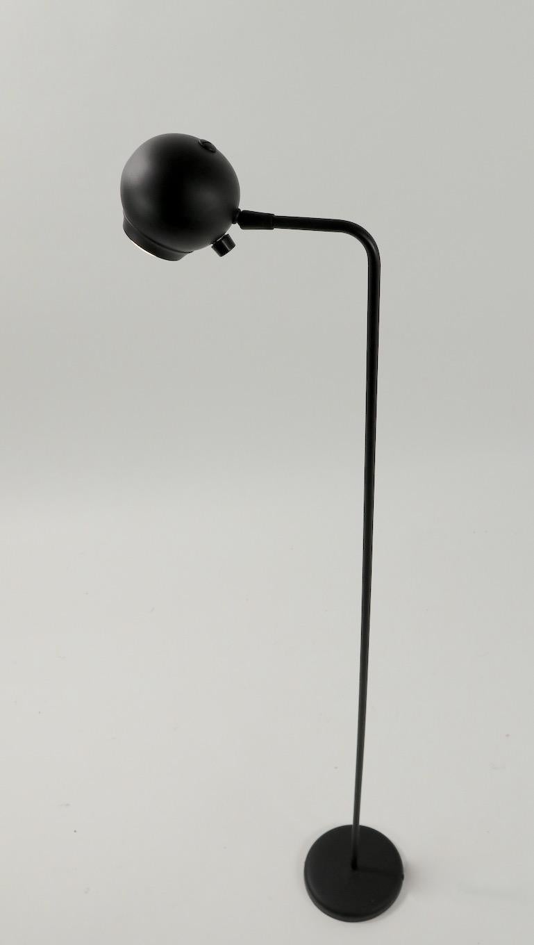 Classic Postmodern adjustable eyeball floor lamp designed by Robert Sonneman for George Kovacs. This example is in original matte black finish, it has an on/off dimmer switch, and is in clean, original and working condition. Ball shade swivels and