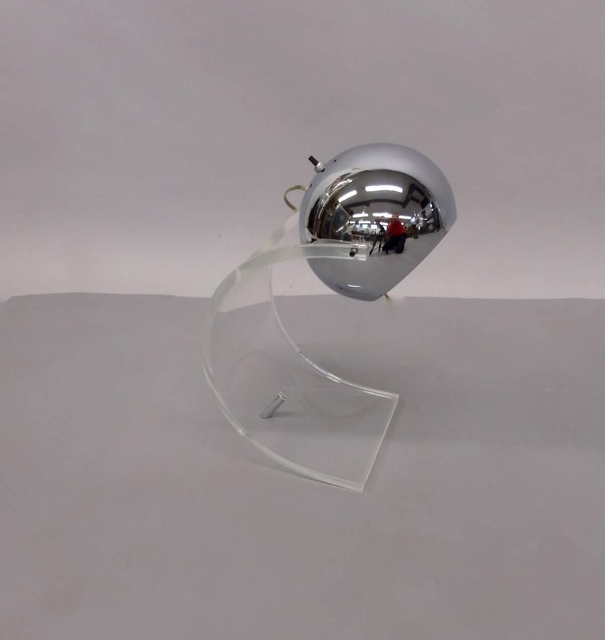 Marked with original label. Sonneman chrome ball in arching wave Lucite acrylic base with single chrome leg. Desk or table lamp in excellent original condition.