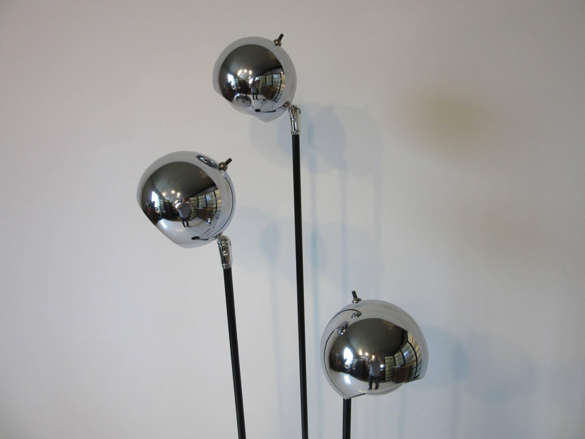 A three staff chromed ball floor lamp with satin black round metal base with chrome details, the balls are adjustable, manufactured by the Robert Sonneman Lamp company.