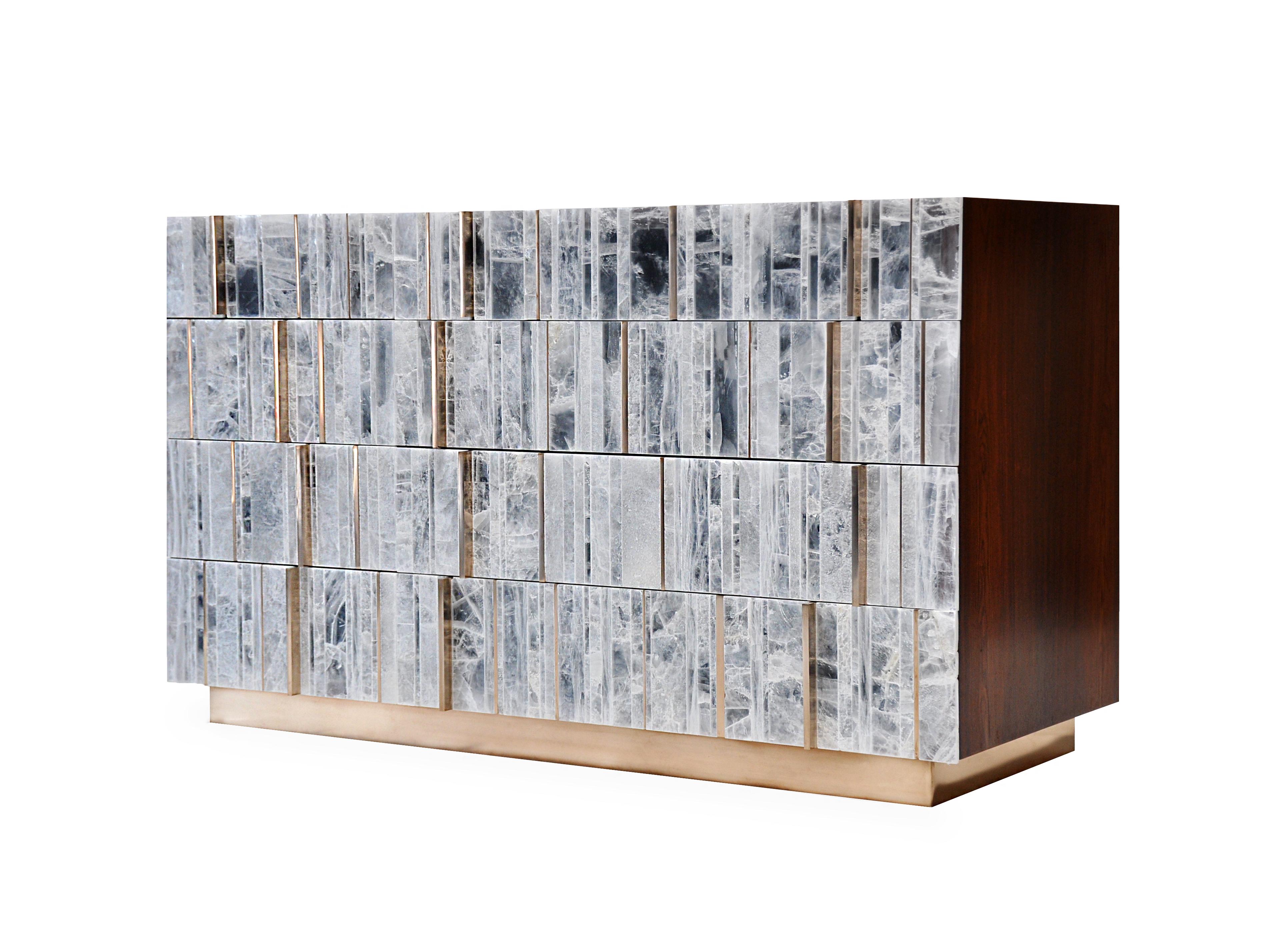 The Sonnet Dresser uses the rhythmic patterns of selenite, hand cut and arranged in vertical pattern along with polished metal inlay and handles to create a beautiful luxurious statement piece. Selenite is a naturally occurring crystalline form of