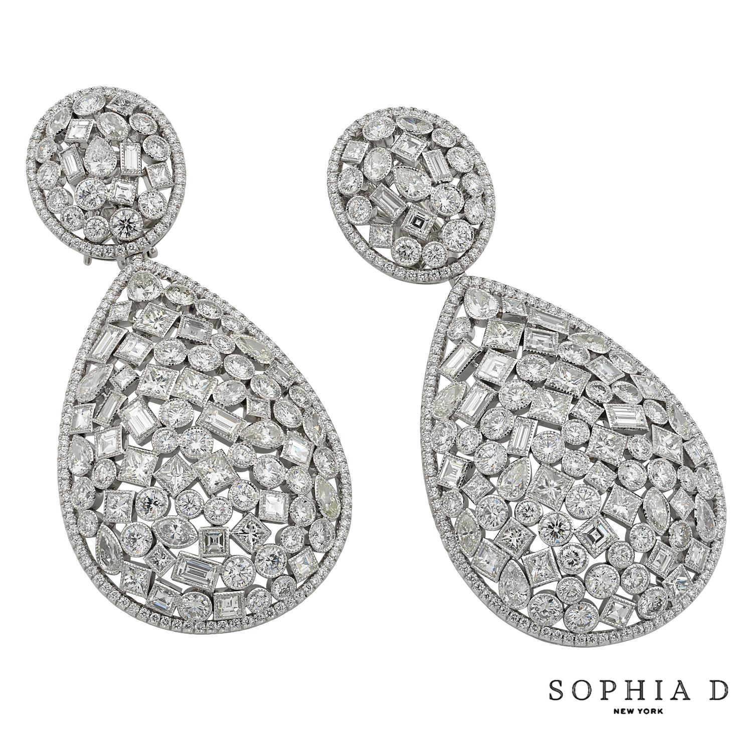 Crafted in sleek platinum, these earrings feature a stunning 18.47 carats of mixed-cut diamonds. The varied cuts create a dynamic interplay of light and sparkle, making these earrings a sophisticated choice for any occasion. Their modern design and