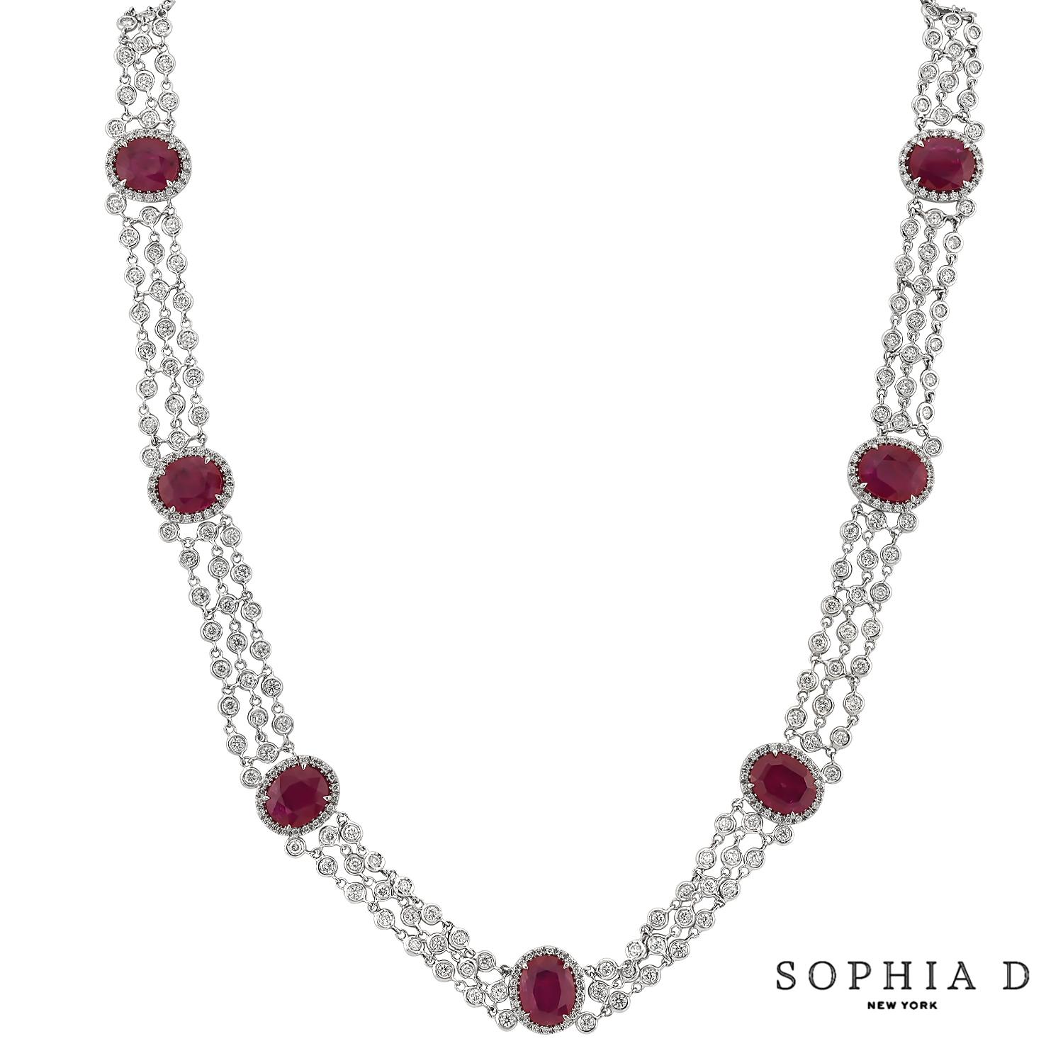 Este elegante collar incluye un impresionante rubí de talla ovalada, con un peso aproximado de 24,99 quilates, engastado en oro blanco de 18 quilates. Alrededor del rubí hay brillantes diamantes que suman 11,44 quilates. La combinación del vibrante