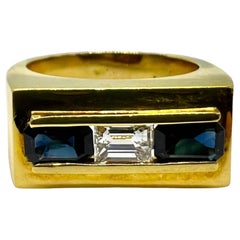 D. A. Anello con zaffiro blu e diamante in oro giallo 18 carati