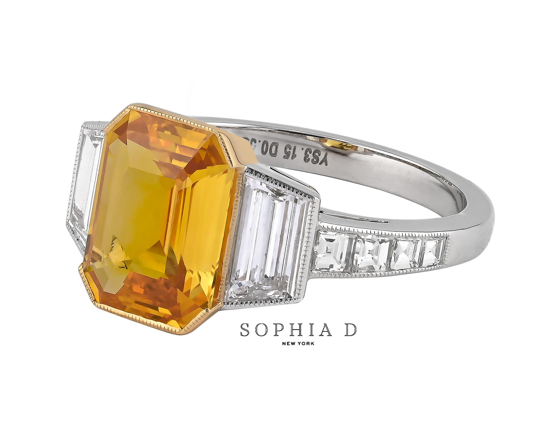 This refined platinum ring showcases a 3.08 carat yellow sapphire, paired with 0.55 carat trapezoid-cut diamonds on either side. The design is further accented by 0.46 carats of additional diamonds, enhancing the overall elegance of the