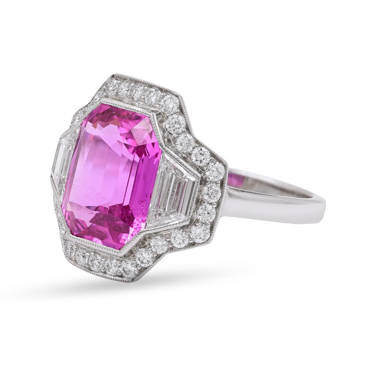 This Sophia D. ring, crafted in platinum, features a 4.28-carat Madagascar pink sapphire, renowned for its exceptional color and clarity. The sapphire is flanked by two trapezoid diamonds, each weighing 0.56 carats, and complemented by an additional