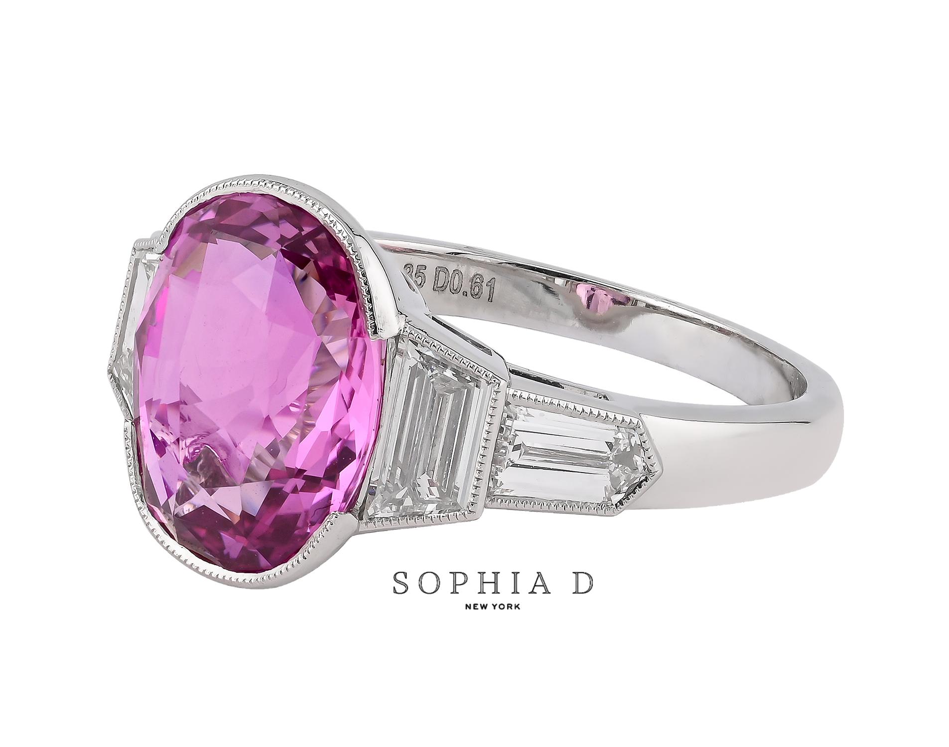 This exquisite platinum ring features a 4.81 carat pink sapphire from Sri Lanka, known for its natural color and no heat treatment. Flanking the sapphire are approximately HVS2 trapezoid-cut diamonds totaling 0.54 carats, positioned on either side