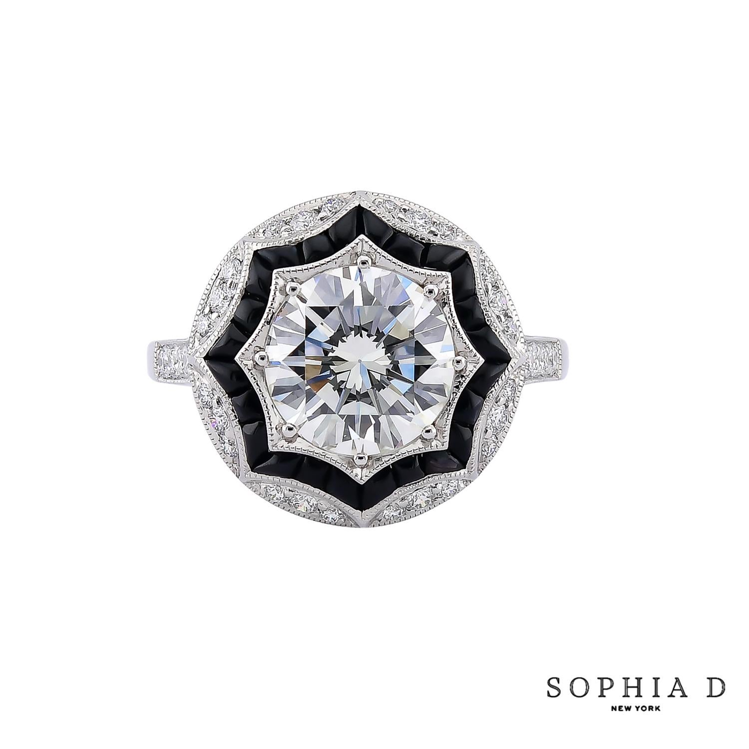 This ring showcases a stunning Art Deco-inspired design, featuring a 2.13-carat center diamond, complemented by 0.53 carats of onyx and 0.29 carats of additional diamonds. The geometric pattern and contrast between the sparkling diamonds and the