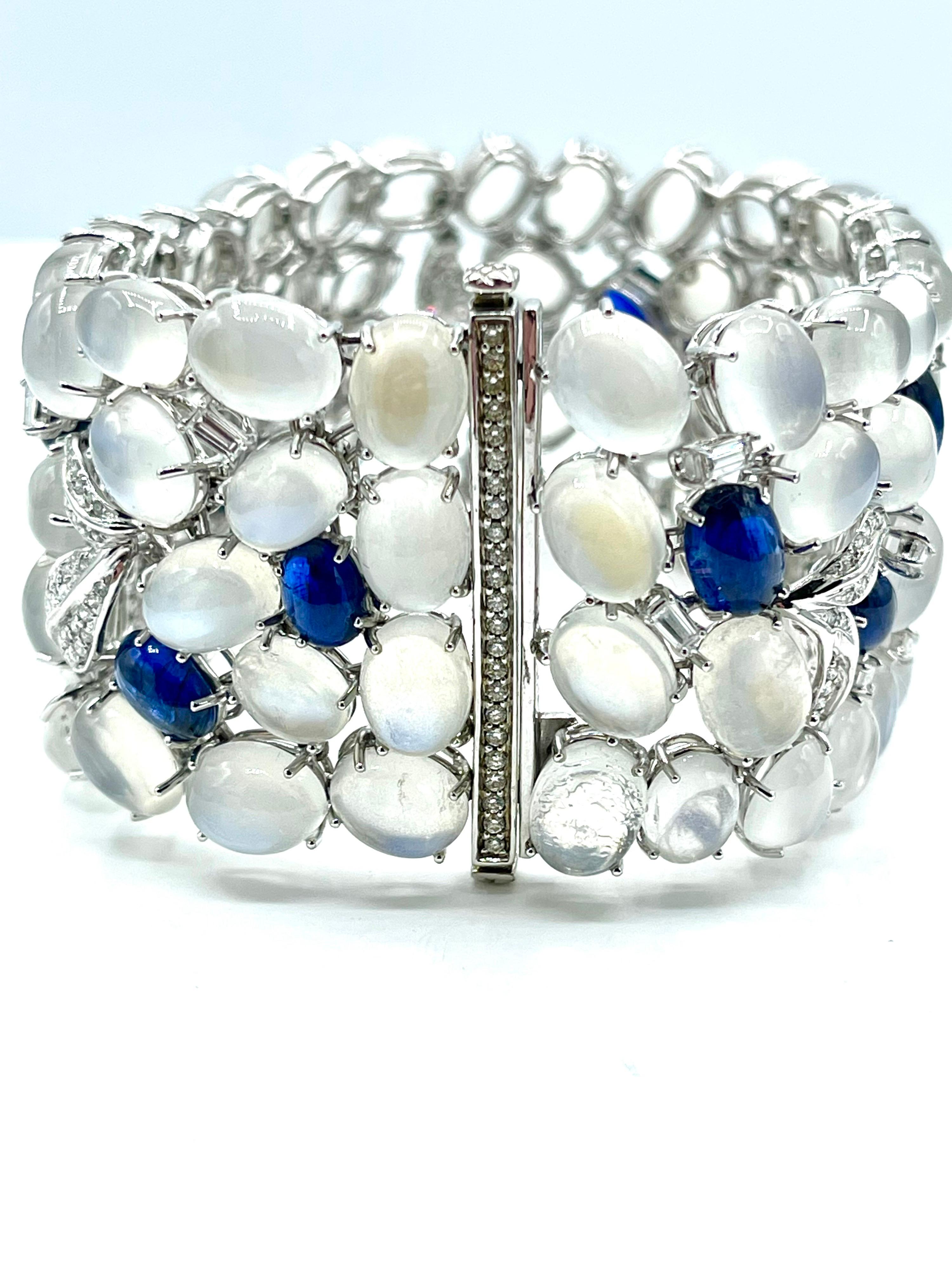 An absolutely stunning bracelet by Sophia D.!  There are a total of 77 cabochon cut Moonstones prong set throughout the bracelet and 12 cabochon cut Sapphires, with emerald cut and round brilliant Diamonds.  The Moonstones display beautiful