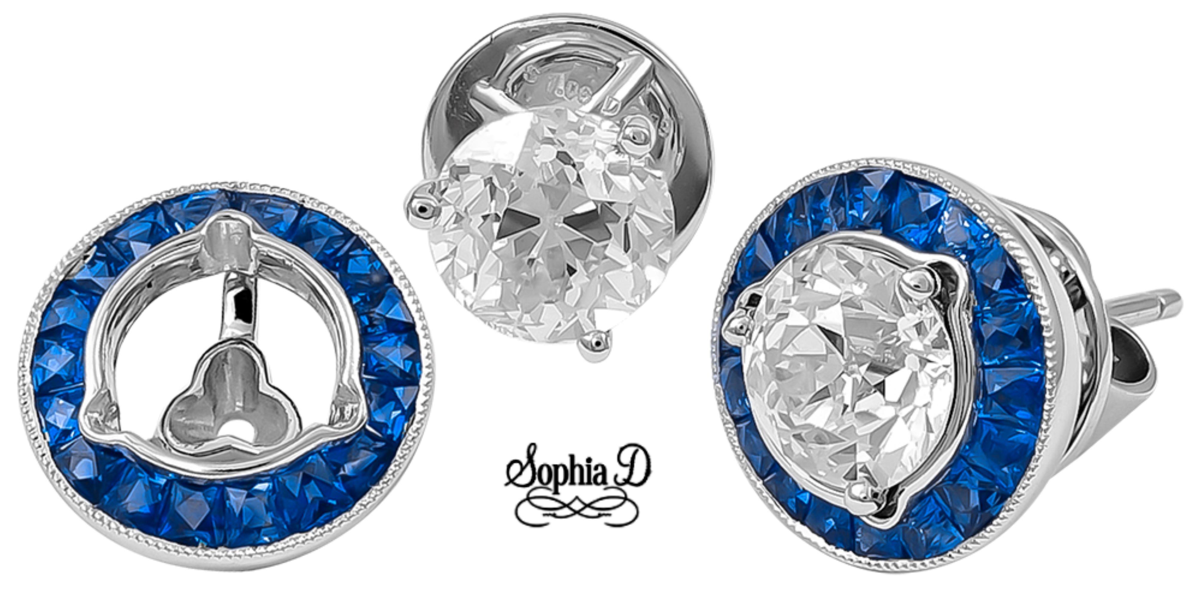 Introducing the Sophia D. Diamond Studs with Blue Sapphire Jackets, crafted in platinum. Each earring features a stunning 1.33 carat and 1.17 carat round diamonds at the center, surrounded by vibrant blue sapphires totaling 1.17 carats. This